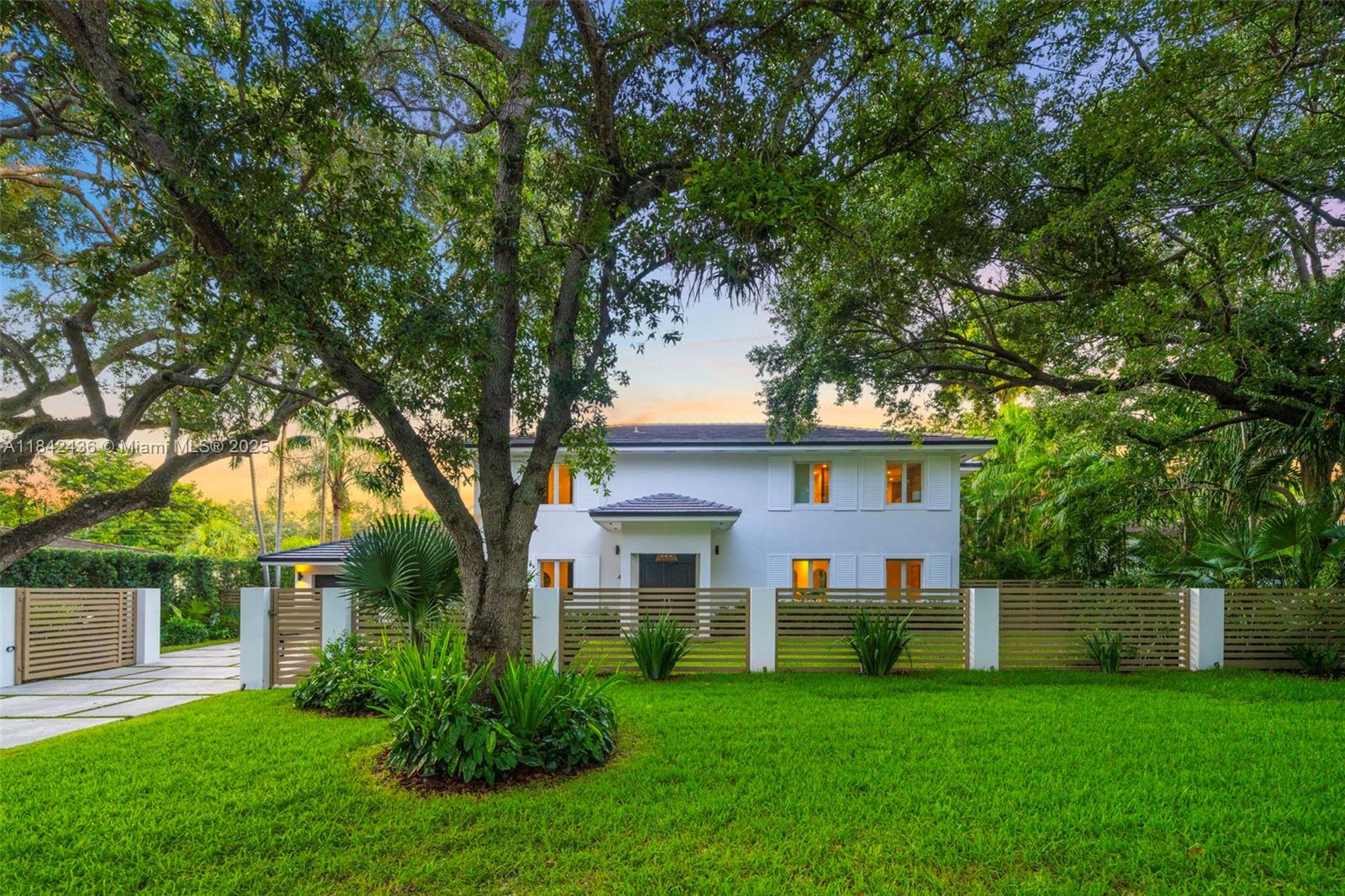 Chic, contemporary, recently renovated residence in the heart of Coral Gables. This home is nestled on a spacious, fenced & gated 11,000 SF oversized lot, adorned with towering oak trees and lush landscaping. Boasting sun-drenched interiors, high ceilings, & an open custom Snaidero kitchen with coffee bar, wine cooler, & Miele and Wolf appliances. Great layout with 3 bedrooms upstairs and 1 downstairs, all with ensuite bathrooms. Perfect for entertaining, enjoy an ultra-private backyard with resort-style pool, jacuzzi, cabana bathroom, & covered gazebo with summer kitchen for Al Fresco dining. Plenty of parking & 2-car garage with projector and golf simulator. Close to top public & private schools: Sunset Elementary, Gulliver, St. Thomas Episcopal, & Ransom Everglades. NOT IN FLOOD ZONE!