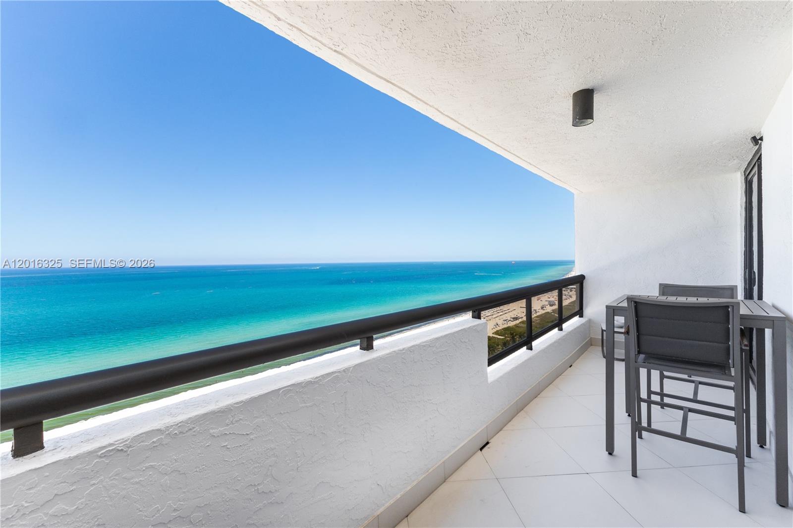 Rarely does a residence of this caliber become available. Featuring breathtaking direct ocean views from every room, this designer-remodeled condo offers exceptional luxury in one of Miami Beach’s most prestigious locations. Completely reimagined with the finest materials and impeccable craftsmanship, this turnkey residence is move-in ready for the most discerning buyer. The open-concept kitchen showcases quartz countertops with waterfall edge, custom soft-close cabinetry,  and stainless appliances including wine cooler for entertaining. Large-format diagonal porcelain flooring extends throughout, complemented by sophisticated architectural elements including custom wave ceiling details, designer lighting and tailored high-end finishes at every turn. The spacious primary suite offers stunning ocean views, walk-in closet, and spa-inspired bath. A second full bathroom provides added convenience for guests. Floor-to-ceiling impact windows & doors open to a private oversized balcony with spectacular sunrise views over the Atlantic Ocean. Offered beautifully furnished with most curated artwork included, the residence presents like a model home. Located in a full-service luxury building with resort-style amenities: 24-hour security, attended lobby, valet, fitness center, convenience store/café, remodeled common areas, assigned parking, pool, bbq, and direct beach access. For buyers seeking uncompromising quality, luxury, and direct oceanfront living, this residence delivers it all.