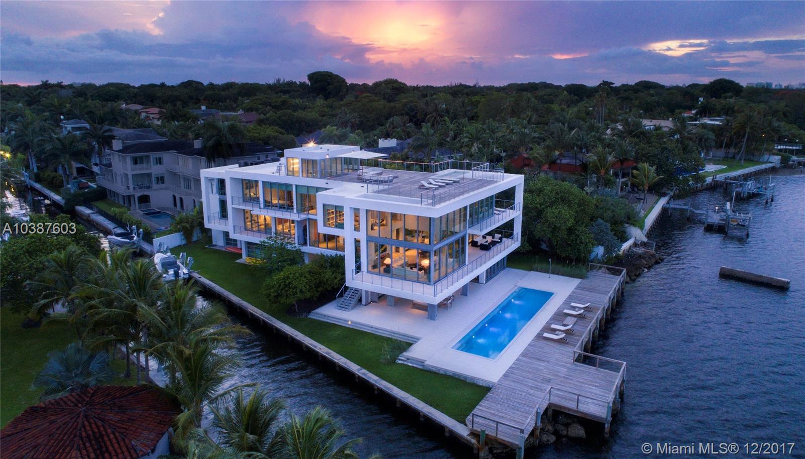 Sleek bayfront Contemporary waterfront home with 350 linear feet of water frontage. Built in 2014 this tri- level 14,000 sq home offers soaring ceilings and generous balconies. 5 bedroom/5 full /7 half baths. It embraces pure modern style and boast insurmountable panoramic open bay and city views. Master Suite includes his/hers walk-in closets and resort style oversized bath with aroma steam shower and private sun terrace. Expansive rooftop with separate plunge pool. 2,000 sq foot double height flex space with loft. Located in an exclusive guard gated community, Entrada Estates. Open flexible design offers timeless simplicity, luxurious living and entertaining spaces. Community tennis court. 60 foot lap pool, gym, elevator, 5 car garage and boat lift.