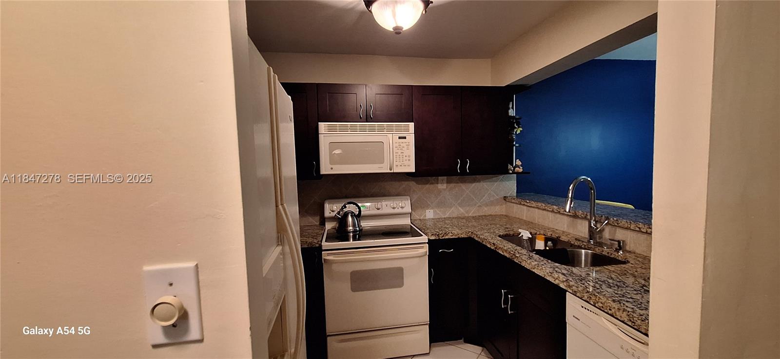 This ground-floor unit features a spacious built-in wine rack with additional closet space.  Updated kitchen with shaker wood cabinet and granite countertop.  Laundry closet inside unit with stacked washer and dryer.  It comes with a large screened porch for your indoor-outdoor relaxation and chats with friends.
Water and waste services are included, and monthly dues cover amenities, common areas, the reserve fund, parking, and more. The north-facing unit comes with one assigned parking spot. For any association-related questions, contact the association manager. Depending on the lender, a 10, 15 or 20% down payment may be required depending on the lender.  Please review for updates to the listing. The 40-year repairs are done and approved, new roof, the unit’s assessment fully paid. Currently rented for $1900 through December 2026.   See attachment for financials and other information.