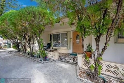 Welcome to this spacious one-story home in East Hallandale Beach, offering comfort, flexibility, and a convenient location.  The property features bright interior living space, an enclosed Florida room, covered patio, circular driveway, and a rear storage structure for added utility. Ideally situated near US-1 and just minutes from the beach, shopping, and dining