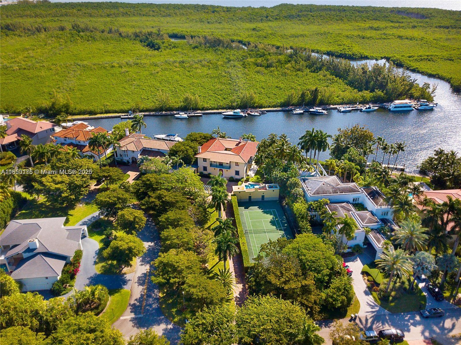 Waterfront Coral Gables Gated Estate with dock, serene unobstructed waterfront views, and professional tennis court on Builders Acre! This Portuondo Perotti designed home, in the quiet guard gated neighborhood of Hammock Oaks, is situated on a 40,000 SF lot with a ±7,000 SF home, 2 Spectacular Tree Houses! This beautiful home has 6 Bed/5.5 Bath (+2 Bonus Rms, Office, Gym Totaling 8 Rms), Living Room and master bedroom with fireplaces, beautiful Courtyard and a separate Barn Style Garage bringing exquisite style to this home! Unobstructed Serene Waterfront Views, includes 12ft Ceilings, Italian Marble, Hardwood Floors, Pool, Cabana, only one bridge to Open Bay, 36’ Dock on Almost 100 Ft Linear Waterfront! Seven Minute Drive to Open Bay! LEAST EXPENSiVE WATERFRONT “ACRE” IN ALL DADE COUNTY