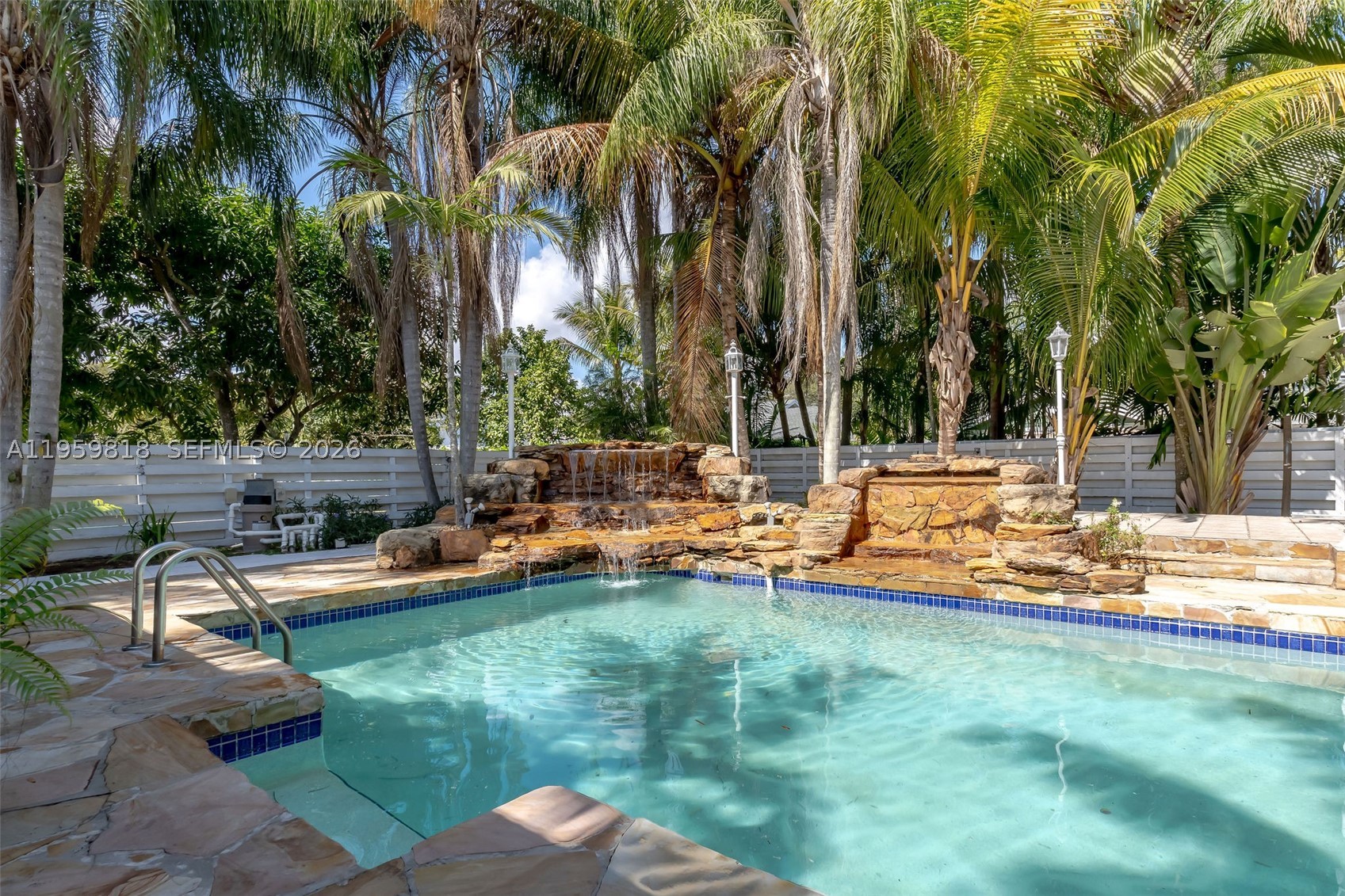 Elegant corner-lot residence in the prestigious Country Walk community, offering privacy, scale, and refined indoor–outdoor living. Built in 1981 and set on an expansive 14,716 SF lot, this 4-bedroom, 4.5-bathroom home spans 3,680 SF of living space and showcases a beautifully resurfaced stone finished pool with elegant fountain feature, new pool pump, and mature mango and avocado trees creating a serene, resort style setting. 

The interior is warm and elevated, featuring sealed pine wood ceilings throughout, ambient lighting, and skylights that flood the home with natural light. A spacious kitchen anchors the home, while a screened outdoor terrace invites effortless entertaining. The primary suite offers a private wellness retreat with an expansive adjoining spa area featuring an integrated sauna, jacuzzi, full bathroom, and dedicated split A/C unit. 

Recent upgrades include a 5-year-old roof and a new TRANE HVAC system with transferable 10-year warranty. Ample parking with a 7-car driveway plus 2-car garage. Miami-Dade Water and Sewer Department has been addressing Country Walk sanitary sewer facilities, providing added infrastructure assurance. 

Low HOA of $176/month includes clubhouse, pool, jacuzzi, tennis, basketball court, and playground. Ideally located near top-rated schools, shopping, and dining.