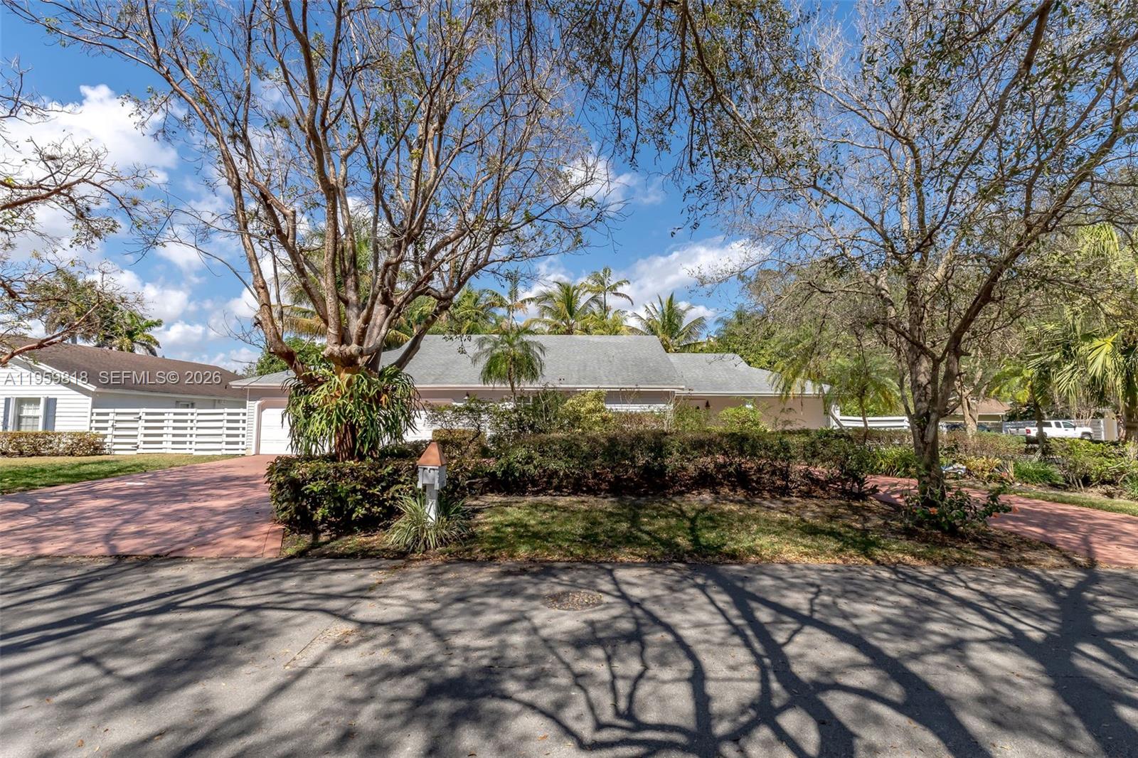Elegant corner-lot residence in the prestigious Country Walk community, offering privacy, scale, and refined indoor–outdoor living. Built in 1981 and set on an expansive 14,716 SF lot, this 4-bedroom, 4.5-bathroom home spans 3,680 SF of living space and showcases a beautifully resurfaced stone finished pool with elegant fountain feature, new pool pump, and mature mango and avocado trees creating a serene, resort style setting. 

The interior is warm and elevated, featuring sealed pine wood ceilings throughout, ambient lighting, and skylights that flood the home with natural light. A spacious kitchen anchors the home, while a screened outdoor terrace invites effortless entertaining. The primary suite offers a private wellness retreat with an expansive adjoining spa area featuring an integrated sauna, jacuzzi, full bathroom, and dedicated split A/C unit. 

Recent upgrades include a 5-year-old roof and a new TRANE HVAC system with transferable 10-year warranty. Ample parking with a 7-car driveway plus 2-car garage. Miami-Dade Water and Sewer Department has been addressing Country Walk sanitary sewer facilities, providing added infrastructure assurance. 

Low HOA of $176/month includes clubhouse, pool, jacuzzi, tennis, basketball court, and playground. Ideally located near top-rated schools, shopping, and dining.