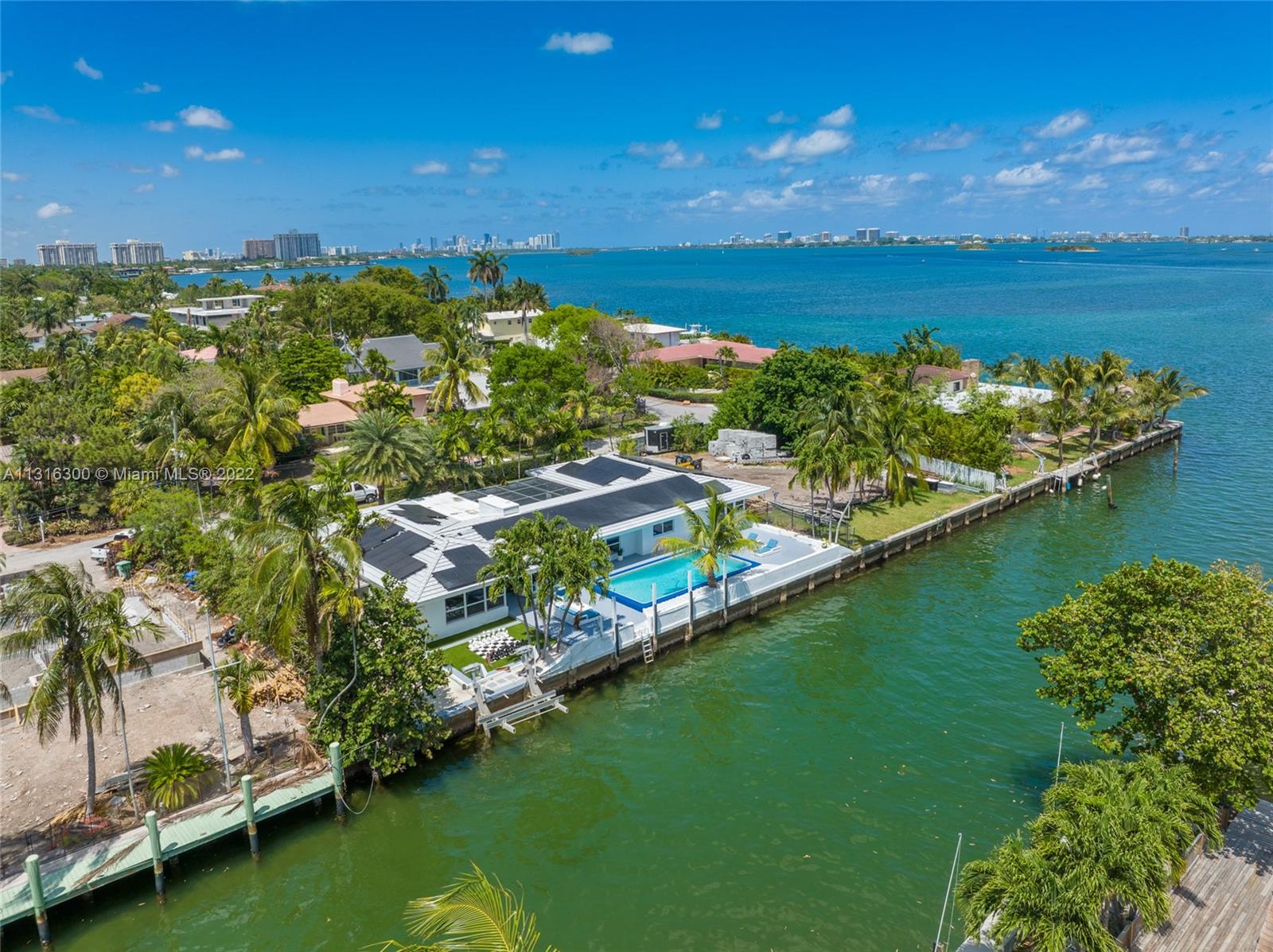 BEST PRICED WATERFRONT (110 FT) 2 LOTS FROM THE OPEN BAY w/ NO FIXED BRIDGES! Once in a lifetime opportunity to own this dream home in the quiet neighborhood of Davis Harbour. This home is perfectly situated only two lots away from the open bay and was previously remodel to fit the look of 2022. Enjoy your evenings either on your screened front patio / zen garden or in the backyard on your oversized Pool overlooking the water with an adjusted living space of over 4000 sqft. The house features 5 bedrooms and 3.5 bathrooms & a huge bonus room with separate A/C which can be used as a game room/movie room. In addition the home features open kitchen with stainless steel appliances, quartz countertops, impact windows, wine fridge & porcelain tile floors and solar panels. Priced to sell!