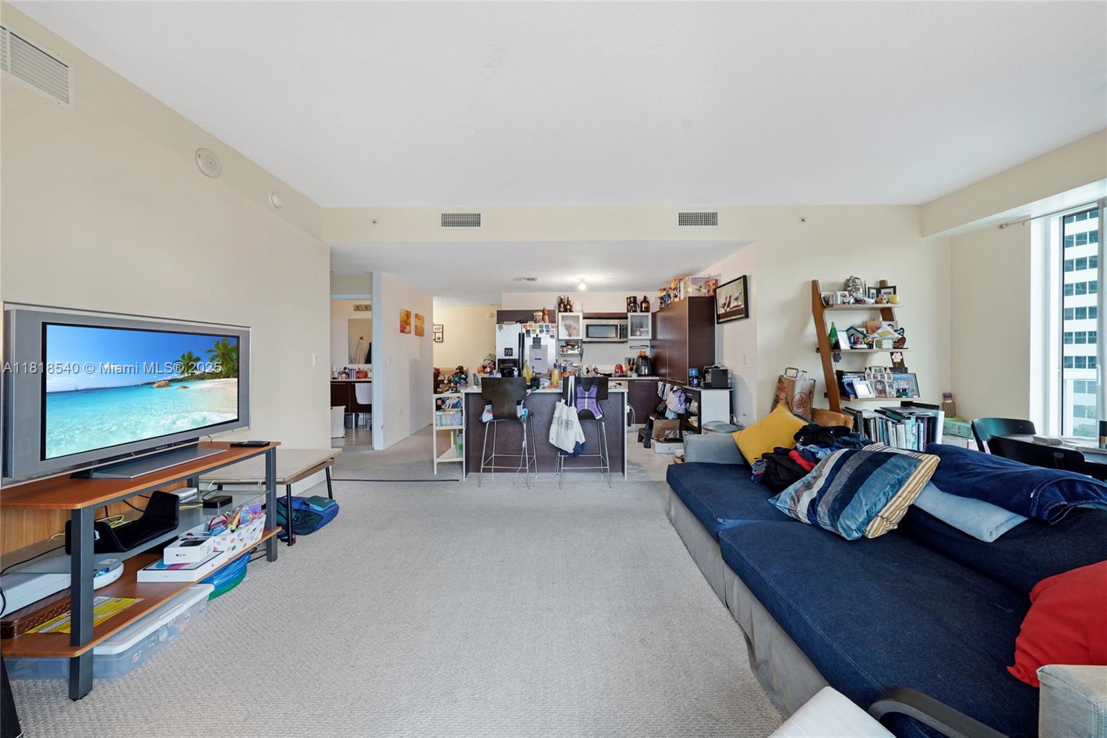 Perched on the 14th floor with city skyline and pool deck views, this spacious corner residence in Miami's sought-after Edgewater neighborhood offers an unbeatable combination of location and potential. Featuring its original 2007 finishes, the condo includes carpet throughout and a generous wraparound balcony ideal for enjoying the urban scenery. The well-appointed kitchen is outfitted with custom wood cabinetry , island  , perfect for everyday living and entertaining.

With impact-resistant sliding doors and windows, this residence offers peace of mind and lasting durability. A rare opportunity to customize and modernize to your taste while enjoying the convenience of a prime location near Wynwood, Midtown, and the Design District.