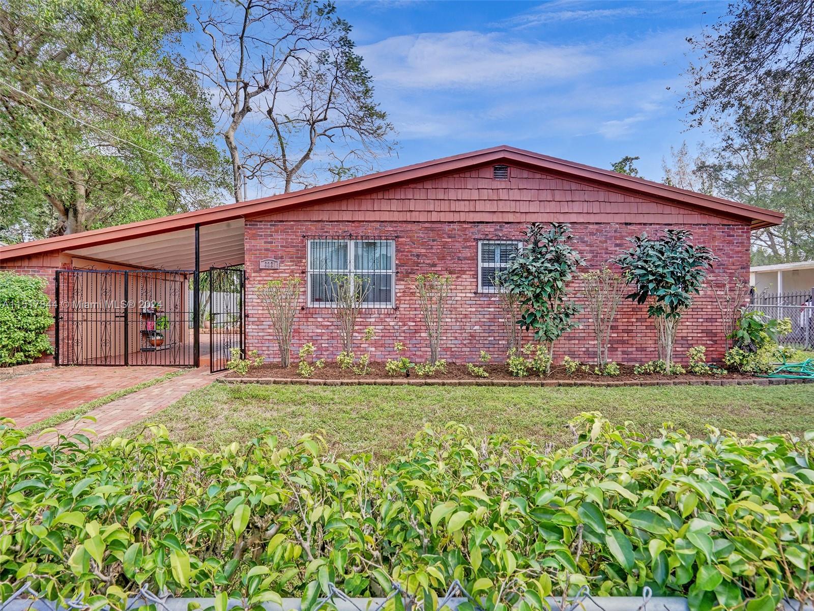 From the moment you walk through the gate, you begin to be transformed by the tranquility found in this home. Inside you will find two very spacious bedrooms and bathrooms with an ample, enclosed Florida room and a quaint galley kitchen. The property is on a huge lot with a lovely garden that leads to your unobstructed view of the lake. The elevation of the yard and home aids in proper water drainage down to the lake. Hurricane-resistant windows along with the bars which can mitigate potential storm damage. Also, it has a usable car port which can protect what is typically the second-most costly family asset--the car as well as the gated parking on the driveway. AC, Roof and Water Heater 2019. Call today to schedule your private showing. This property is a must see!