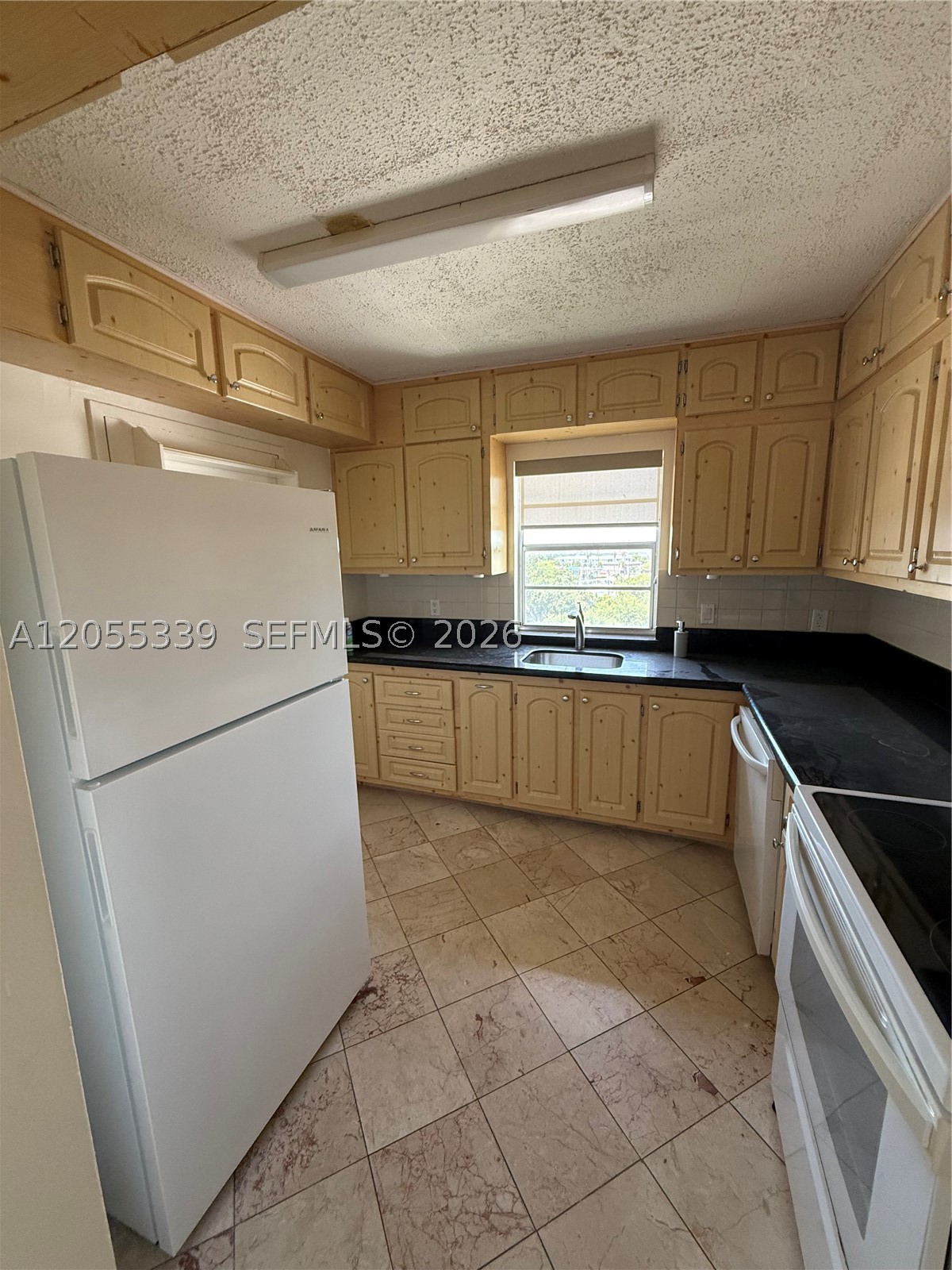 FOR RENT! Bright and spacious 2-bedroom + den, 2-bathroom condo in a prime location. This well-maintained home features marble flooring throughout, a functional kitchen with granite countertops, generous cabinet space, a pantry, and plenty of natural light. Relax on the oversized private balcony with serene canal views. Conveniently located near I-95, the Palmetto Expressway, Florida's Turnpike, Aventura Mall, beautiful beaches, restaurants, shopping, and Oleta River State Park. The building offers gated parking and a secured lobby with an intercom entry system. Please note: The building is currently undergoing improvements, including interior plumbing and balcony repairs, to further enhance the property. A fantastic opportunity to rent in the heart of North Miami Beach! THE APARMENT HAVE DEN ADDITIONAL.