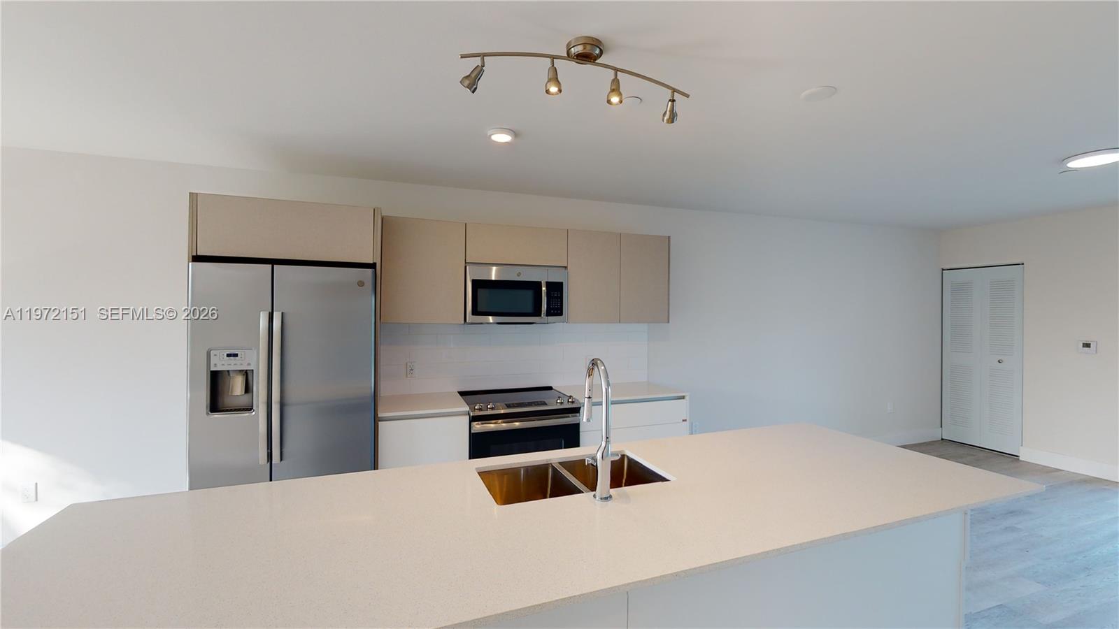 Contemporary 2-bedroom, 2.5-bathroom plus den unit designed for modern comfort. This two-story residence is located on the second floor of the building. The entry level features a sleek kitchen with quartz countertops and state-of-the-art stainless steel appliances, an open living/dining area, a private balcony, and a guest half-bathroom. The upper level hosts two bedrooms—including a primary suite with an en-suite bath and walk-in closet—built-in storage, a second full bathroom with a tub, a versatile den, and a laundry center. The unit features laminate wood floors throughout with tile in the bathrooms. Includes 1 assigned parking space. Residents enjoy a community pool and barbecue area in a prime location near Aventura with easy access to I-95.