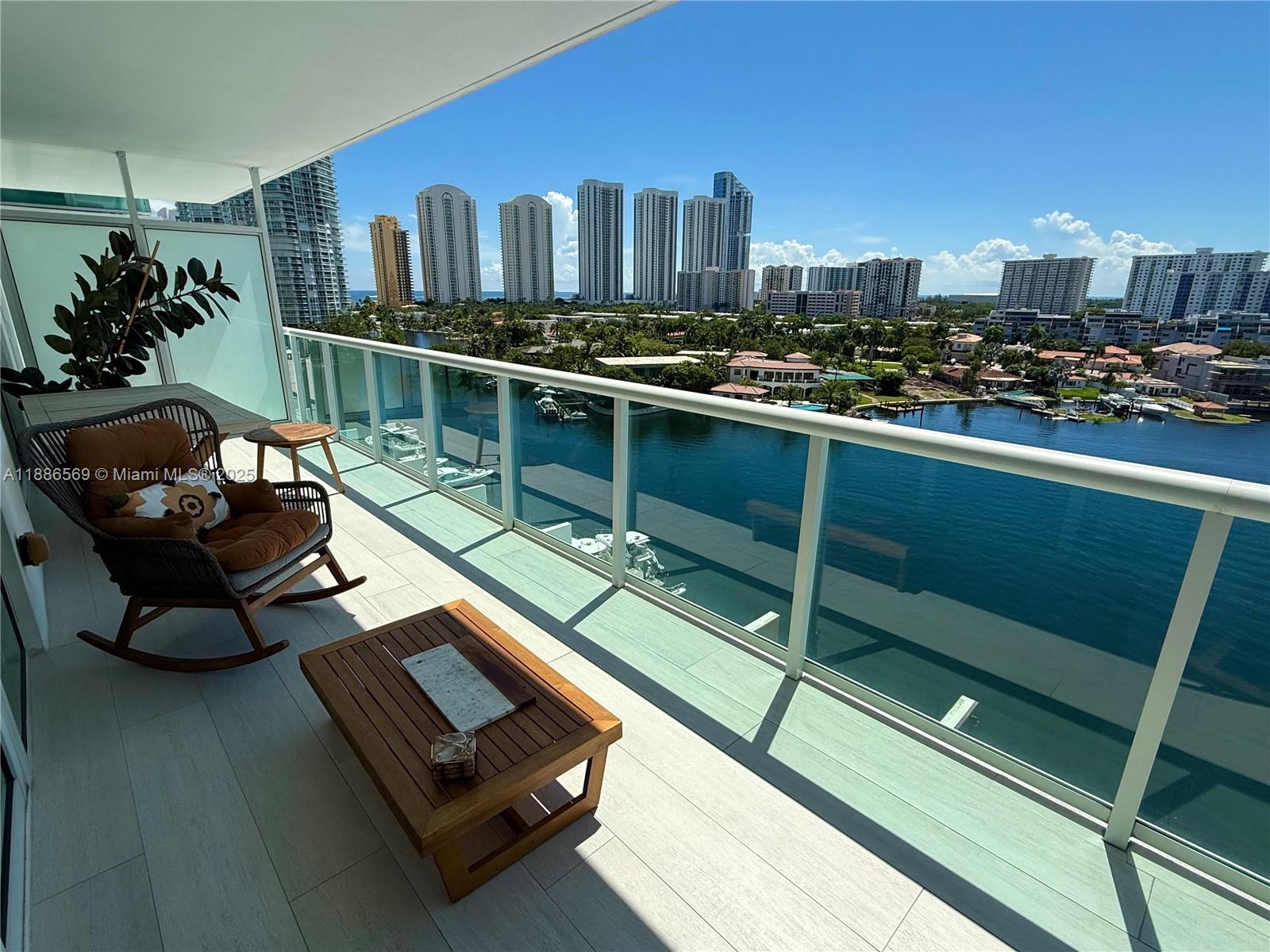 Experience Luxury waterfront living in this impressive condominium. This spacious residence offers two large bedrooms on a separate lever with breathtaking views of the bay and Oleta Park, along with three full bathrooms and a large den that can easily be converted into a third bedroom. The home features and open concept kitchen with top of the line appliances, electric blind, Italian porcelain flooring, and an expansive balcony perfect for entertaining or relaxing. One assigned parking space plus and other valet service. Enjoy resort style amenities such as tennis court, swimming pool, spa, gym, and poolside lounge area. Marina is available managed by a third party.