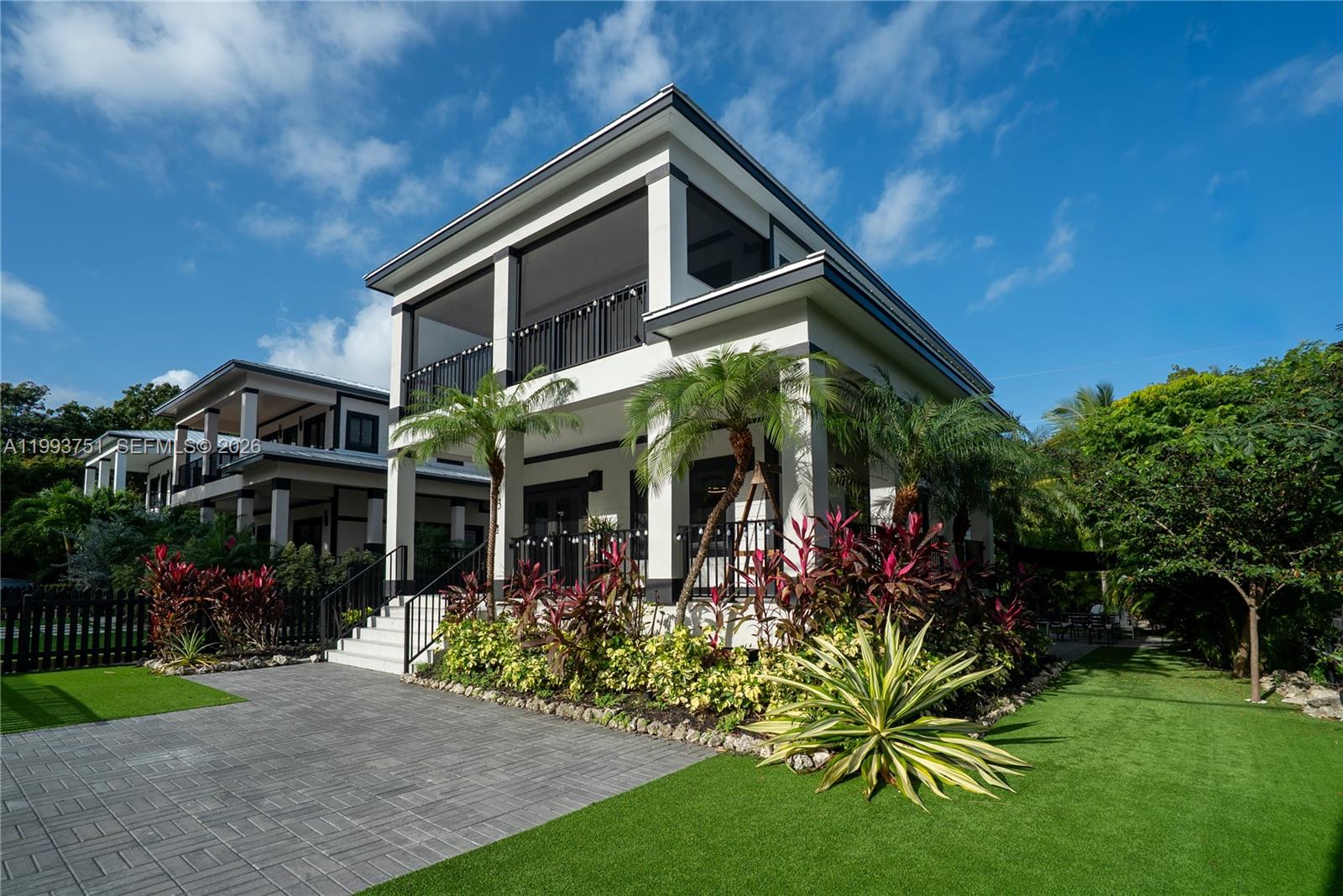 Elegant two story concrete home in Key Largo! Built in 2022, this modern yet timeless residence is just under 2000sqft, located on a fully fenced & beautifully landscaped corner lot. The gated paver driveway leads to the covered wrap around porch, perfect for enjoying lazy afternoons in the shade. Inside, the open living area offers large impact windows and doors letting in lots of light. An open gourmet kitchen is complimented with quartz countertops, tile backslash, modern stainless steel appliances along with an oversized island, perfect for entertaining family & friends. On this floor is a powder room, large storage closet/pantry & a guest room with ensuite bath. Upstairs, is the primary bedroom with a walk in closet, en suite bath and private screened patio for enjoying your morning rituals. Down the hall past the laundry & linen closets is another large bedroom with two closets and an ensuite bath. The desirable corner lot is landscaped for privacy and has turf for ease of maintenance. There is room for a pool as well. 2022 concrete construction, metal roof, impact windows give you piece of mind along with lower insurance rates. This location offers an easy commute to the mainland, Ocean Reef Club, the College of the FL Keys new campus, and of course the dining, shopping & marinas the Keys are known for. The island lifestyle can be yours!