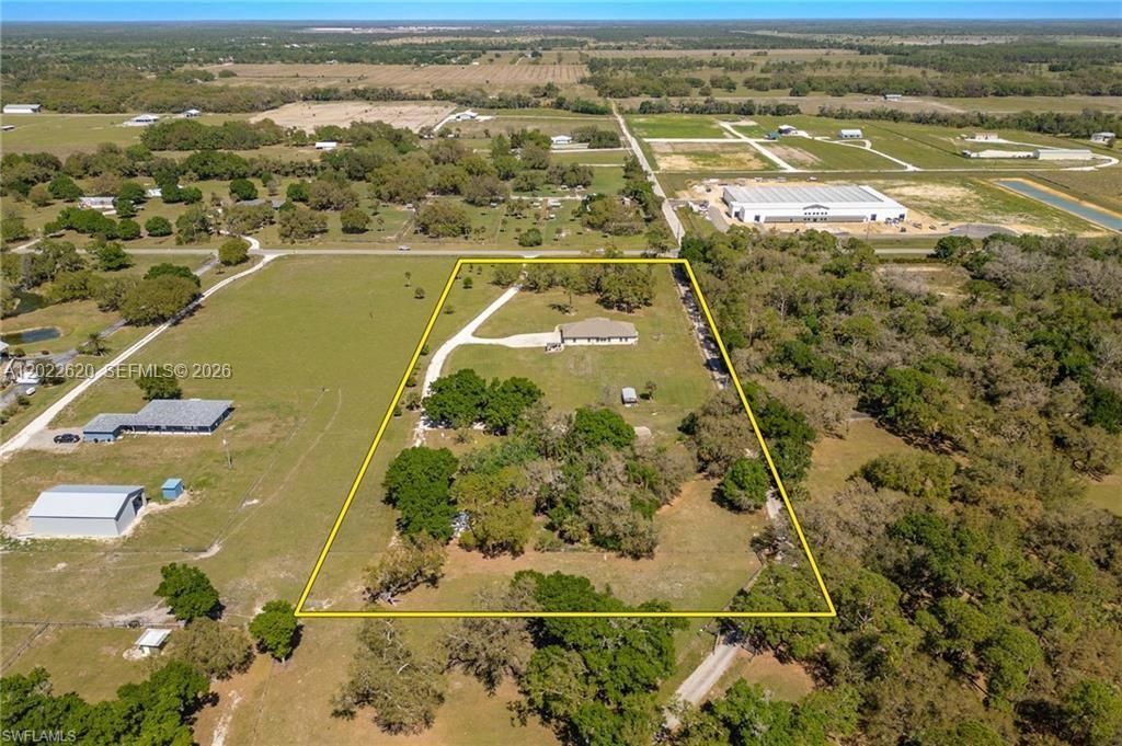 Two homes on 5.75± acres in the historic Fort Denaud area—perfect for multigenerational living, a family compound, or anyone needing space, privacy, and flexibility. The main home offers 3,070 sq ft under air with five bedrooms, three full baths, and a half bath. Cathedral ceilings and polished concrete floors create a bright, open feel, while level 4 granite adds an upscale touch. Built with 8-inch concrete exterior walls, low-maintenance materials, and thoughtful design, this home is made to last. Highlights include: • Open kitchen with abundant storage, dovetail soft-close cabinetry, recessed lighting, and a brand-new stove • Walk-in closets in every bedroom • Master suite with private office or nursery • Entire room dedicated to extra storage • 400-amp electric service and oversized septic sized for two additional bedrooms and baths • Impact windows and doors • Energy-efficient reflective roof plywood and enhanced attic insulation At the southern end of the property sits the 1,620 sq ft guest house at 1301 Jacks Ln, offering three bedrooms, two baths, and numerous updates: new HVAC with ductwork, fresh exterior paint, updated plumbing and lighting, new gutters, and added attic insulation. Ideal for extended family, guests, or rental income. The 5.75± acre parcel is zoned for horses and livestock, giving you the freedom to enjoy true country living while still being close to town. A rare opportunity to own a versatile, move-in-ready compound with room to grow