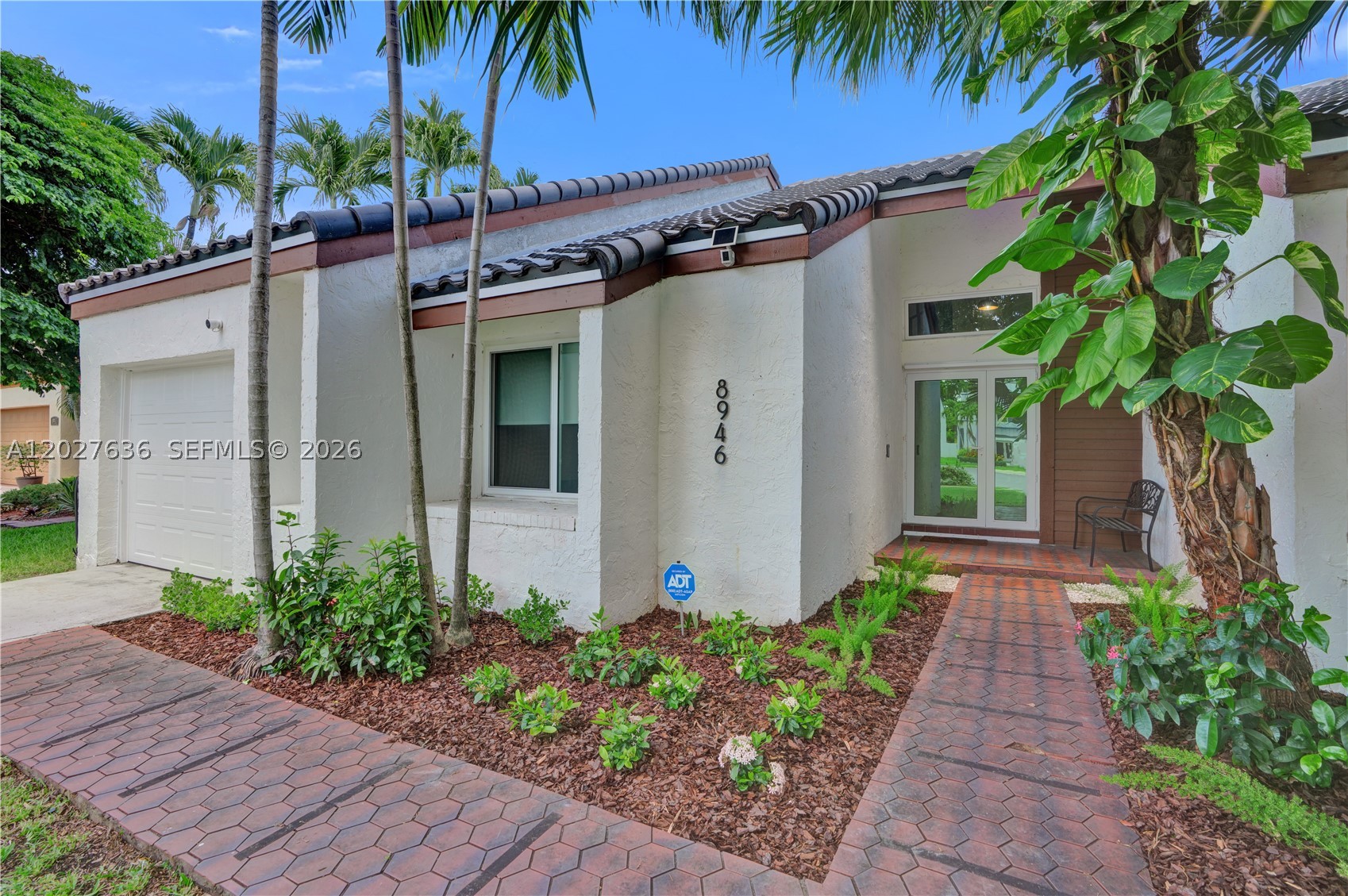 Beautiful 2-story detached home in desirable Hammocks Sec. 1 featuring 3 bedrooms, 2 baths, 2,063 SF of living area, a 1-car garage, and a fenced 6,789 SF yard. Major recent updates include a 2024 tile roof, 2024 impact windows and doors, 2024 water heater, 2024 refrigerator, 2024 garage door and opener, 2024 washer, laminate flooring throughout, automatic blinds installed in the master bedroom and 2023 exterior A/C compressor. Enjoy bright, open living spaces, a modern kitchen, a spacious family room with a working fireplace, updated baths, a spacious primary bedroom, and a private backyard ideal for relaxing or entertaining. Seller reports NOT in a Flood Zone. Existing VA loan at 5.375% may be assumable by a qualified buyer, subject to lender/servicer/VA approval and all assumption requirements. Roof PACE loan to be paid off at closing. 3rd bedroom on the second floor off a spiral staircase.  Note that the current American Home Shield home warranty is transferable to the new buyer at closing. Security cameras are excluded from the sale.