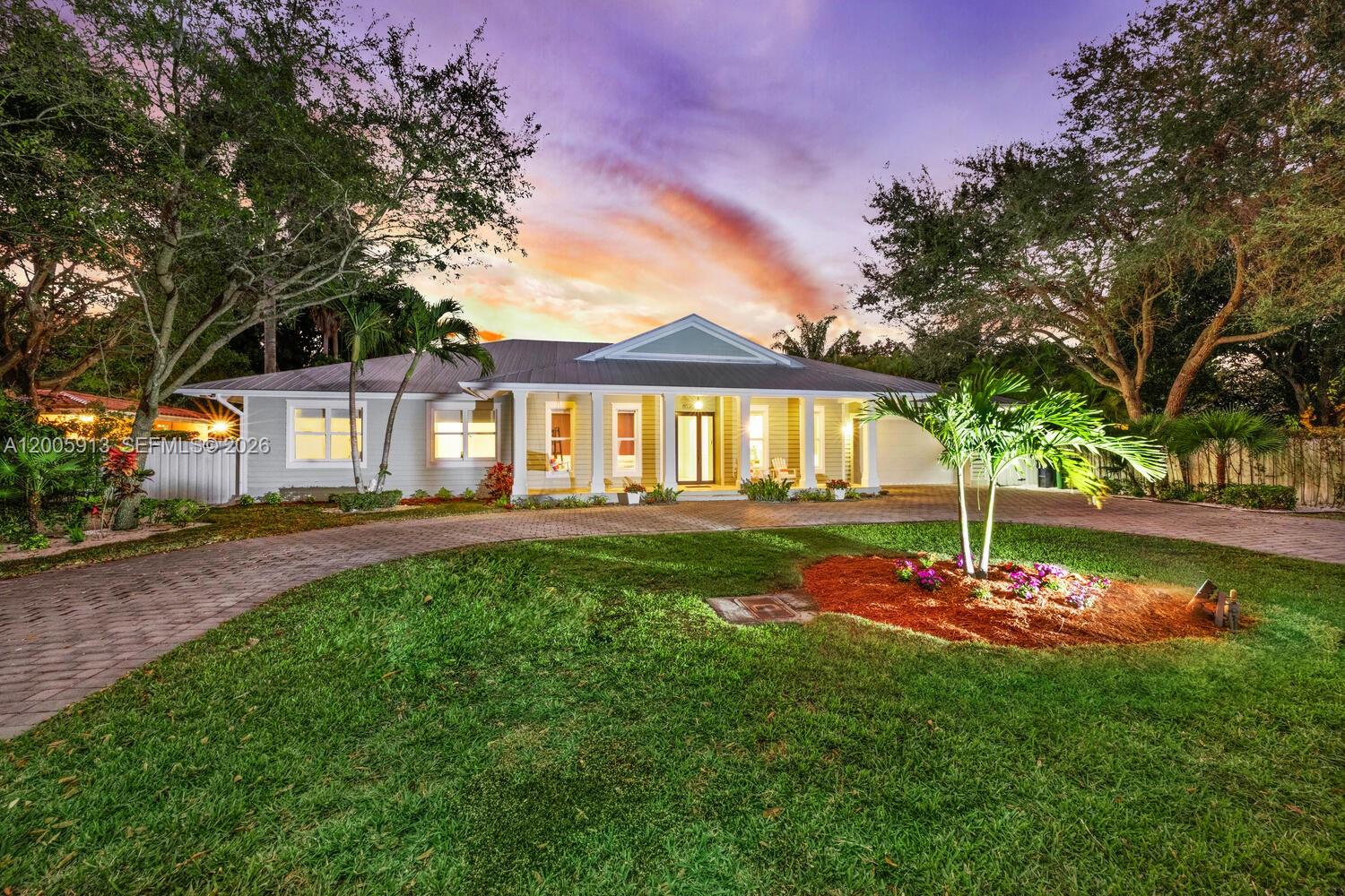 Inviting one story residence, located in a sought after South Miami residential neighborhood, offering 4 bedrooms & 3.5 bathrooms on a 12,000 sqft lot. A circular driveway leads to a light filled interior with 12 foot vaulted ceilings, marble floors in the main living areas, & wood floors in the bedrooms. The layout includes a spacious primary suite with dual sinks & a soaking tub, two bedrooms sharing a dual sink bath, plus a guest bedroom with a full bath that also serves as a cabana bath, & a conveniently placed powder room. The marble kitchen with a butlers pantry & wine refrigerator opens to the formal dining area & a comfortable family room. Outdoor living area with a large pool, ideal for entertaining. Additional features: impact windows, metal roof, laundry room, two car garage.