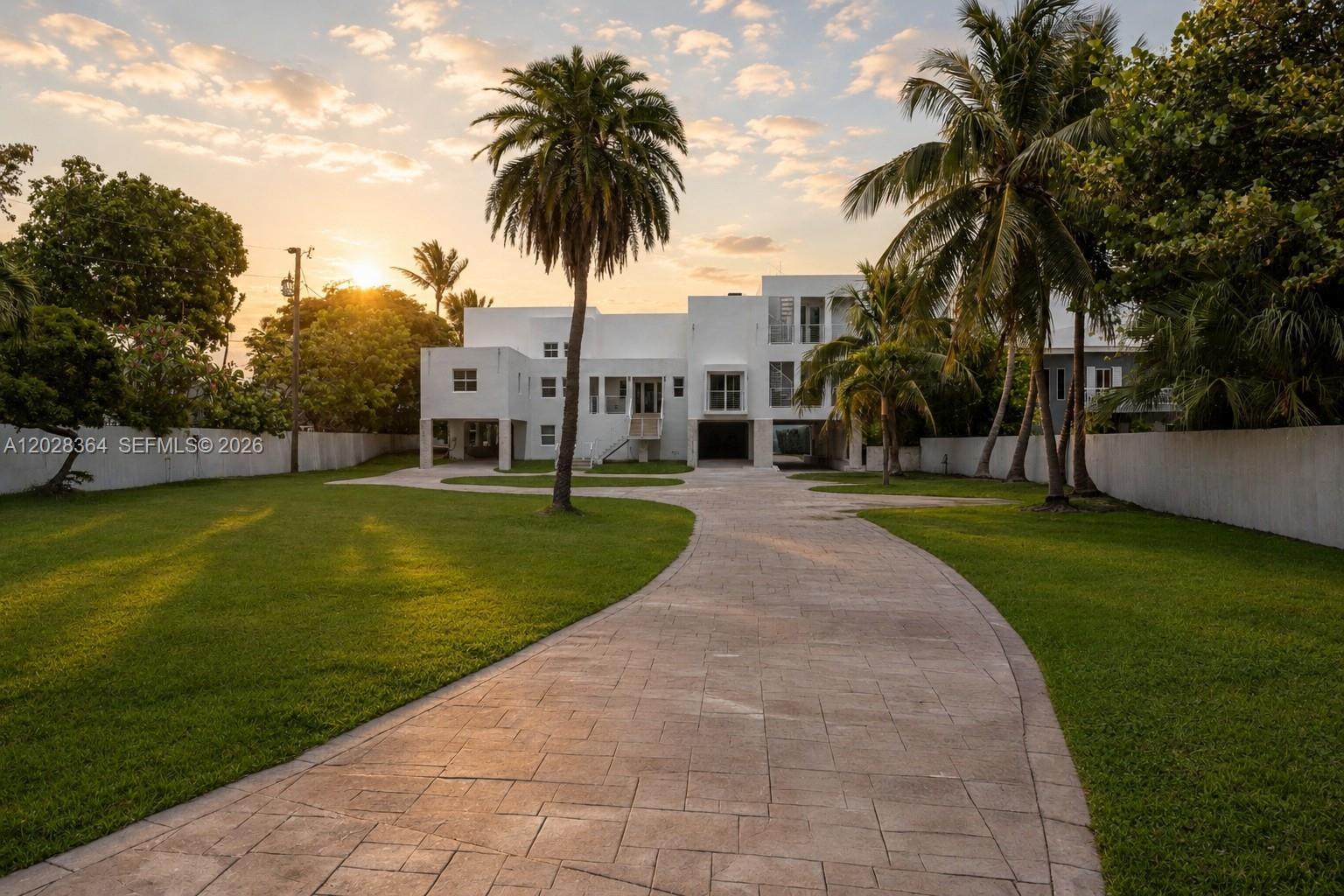 Behind private gates on prestigious Million Air Row, this exceptional oceanfront estate spans nearly 2.5 acres and offers a rare blend of luxury, privacy, and future potential. The recently renovated residence features 8 bedrooms, 7.5 bathrooms, double-height ceilings, spacious bedroom suites, abundant storage throughout, solid CBS construction, impact windows and doors, and a new concrete roof. Designed for the ultimate Florida Keys lifestyle, the property boasts protected basin dockage with a 24,000 lb boat lift, a private helicopter pad, hot yoga studio, resort-style pool with waterslides, waterfall, and spa, plus two covered carports and a large garage. Expansive grounds provide endless opportunities to add additional amenities such as pickleball, volleyball, guest accommodations, or a private beach retreat. A truly unique waterfront compound offering the space and exclusivity rarely found in the Florida Keys.