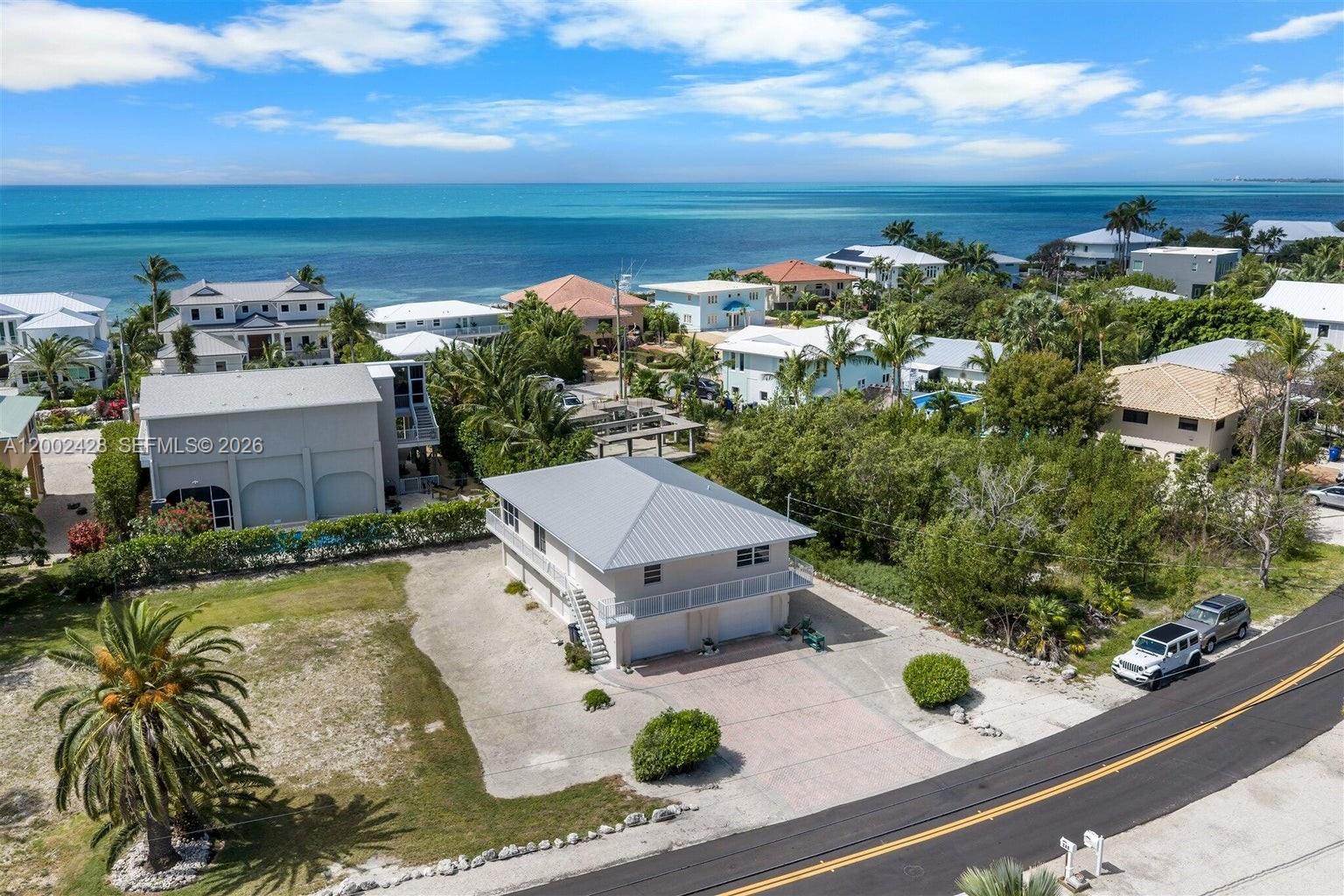 Discover one of the best values in Duck Key -- a spotlessly maintained, move-in-ready two bedroom two bath home on Plantation Island that checks every box for the savvy first-time Keys buyer or the discerning second-home seeker looking for low-maintenance island living at one of the best neighborhoods in the Middle Keys. This spacious, elevated residence welcomes you with an open, airy floor plan that feels expansive from the moment you walk in. Natural light pours through generous living spaces designed for easy entertaining and effortless everyday comfort. Step out onto the screened balcony and let the warm Keys breeze remind you exactly why you fell in love with this place. What truly sets this home apart is the jaw-dropping four-car garage -- an extraordinary luxury in the Keys that gives you all the room you need for vehicles, golf carts, water toys, and gear, with plenty left over. No more hunting for storage. No more compromises. Whether you're searching for your first foothold in paradise or a beautifully turnkey retreat that practically takes care of itself, this Duck Key gem delivers the lifestyle without the hassle. Priced to make your Keys dream a reality today. Exceptional value. Unbeatable location. This is the one!
