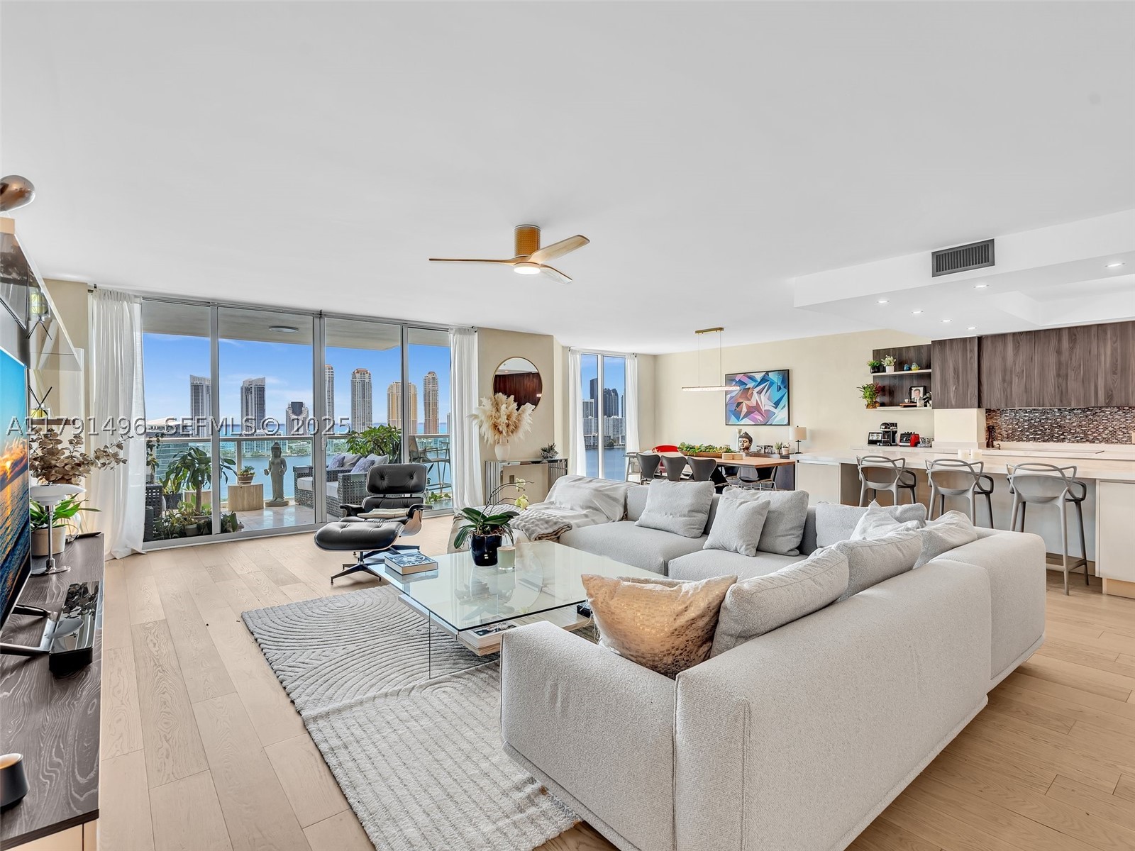 Wake up to breathtaking ocean sunrises and unwind each evening with spectacular sunset views from this beautifully reimagined residence at Peninsula One. Offering 3,298 square feet of impeccably designed living space, this home blends sophisticated style with exceptional comfort in one of Aventura's premier waterfront communities.

A private elevator welcomes you into an elegant foyer that opens to expansive living and dining areas designed for both everyday living and effortless entertaining. The thoughtfully designed floor plan features three spacious bedrooms, three beautifully appointed bathrooms, and a versatile media room that can easily function as a fourth bedroom, home office, or guest suite.

Every detail has been carefully curated, from the wide-plank wood flooring and custom walk-in closets to the stunning Italian-designed kitchen featuring premium appliances, abundant cabinetry, generous prep space, and a bright, open layout that seamlessly connects to the living areas.

Peninsula One offers an exceptional resort lifestyle with two state-of-the-art fitness centers, two waterfront pools, three tennis courts, a full-service spa, children's playroom, social lounge, café, 24-hour concierge, valet parking, private storage, and gated security.

A residence that offers the perfect balance of luxury, comfort, and panoramic water views—all just minutes from world-class shopping, dining, golf courses, parks, and the beaches.