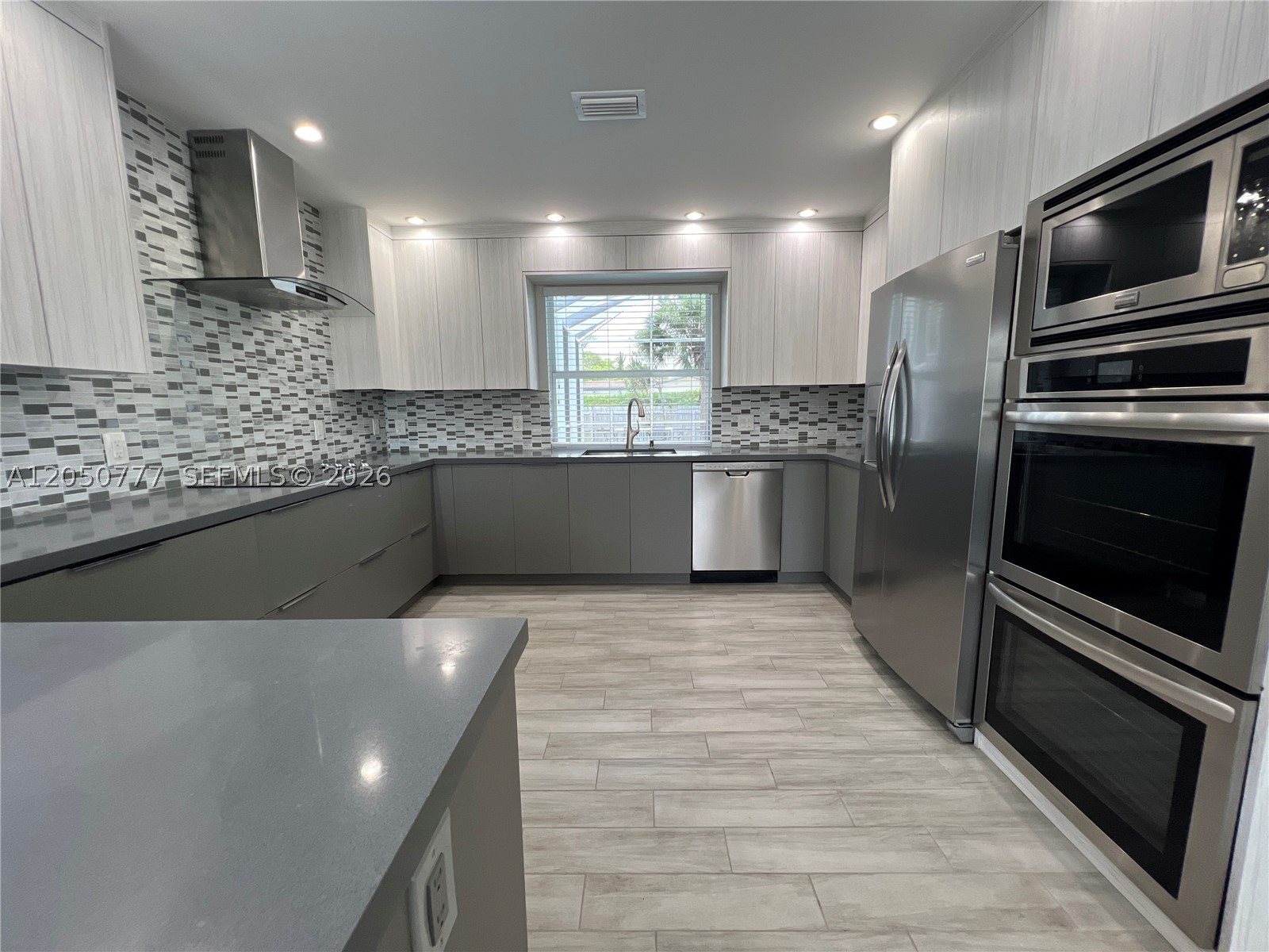 Open House July 18. Fully remodeled pool home in sought-after Hollywood Hills on an oversized 8,787 SQFT lot with NO HOA. This move-in-ready residence offers 1,862 SQFT with an open-concept layout, impact windows and doors throughout, and quality modern finishes. A spacious additional room functions as a potential fourth bedroom, home office, playroom, media room, or guest suite, providing the flexibility of a 4-bedroom floor plan. The upgraded kitchen features custom cabinetry, quartz countertops, and ample workspace for everyday living and entertaining. The private backyard includes a screened, heated pool, creating the ideal space to relax or host family and friends year-round. Conveniently located minutes from Hollywood Beach, Fort Lauderdale-Hollywood International Airport, major hospitals, shopping, dining, parks, houses of worship, and top-rated schools. A turnkey home offering space, flexibility, and an exceptional location.