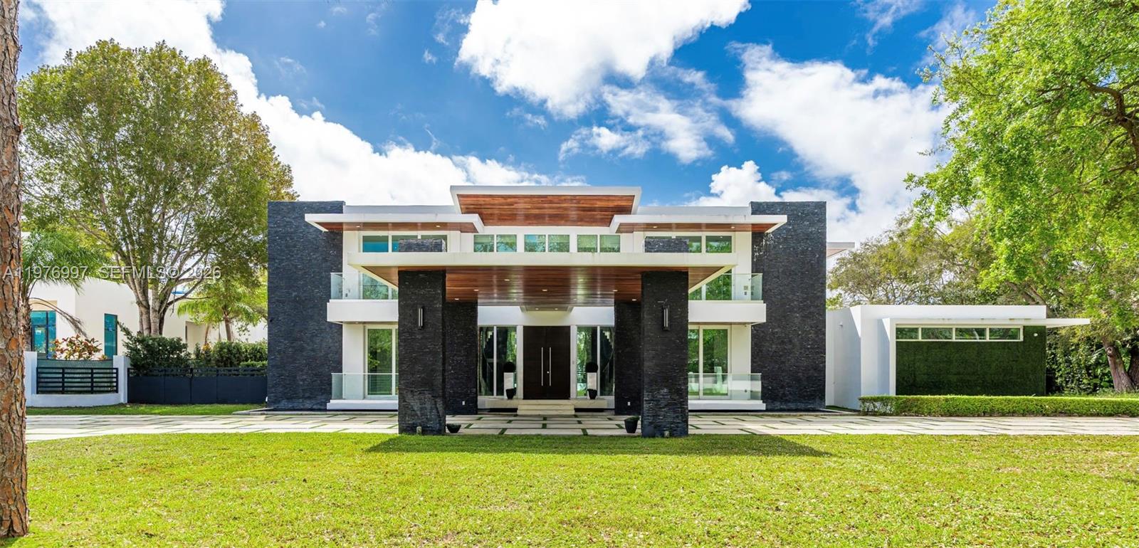 Motivated Seller ,Bring All Offers!
La Premiere Realty is pleased to introduce this extraordinary 2020 contemporary estate in Pinecrest, where architectural brilliance and refined luxury meet behind private gates. Spanning 10,122 sqft of adjusted living area, the residence showcases a striking modern façade with clean lines, natural stone accents, and a dramatic covered entrance that sets the tone for the elegance within.
This exceptional residence features 8 bedroom, 10/1 bathroom, a private elevator, and a 3-car garage, all finished with impeccable craftsmanship and high-end materials. At the heart of the home lies a gourmet chef’s kitchen equipped with premium Wolf appliances, custom cabinetry, and generous preparation space, perfect for entertaining.
The primary suite offers tranquil views of the resort style backyard, two expansive walk-in closets, and a spa-inspired marble bathroom with a soaking tub and oversized glass shower.
The estate includes a complete security system and integrated speakers throughout the home.Enjoy a stunning infinity edge pool, sunken lounge, and covered summer kitchen surrounded by mature palms, creating a private resort-style setting.