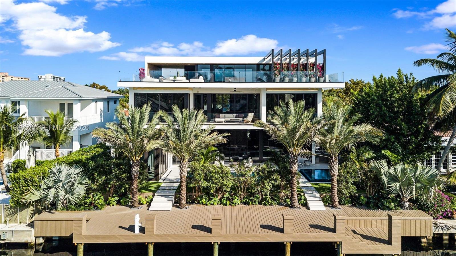 This expansive waterfront residence is located within the gated community of Keystone and offers approximately 6,700 square feet under air and 12,800 square feet total. Featuring 75 feet of direct water frontage with private dock access, the home is designed for both refined living and exceptional entertaining. Highlights include a dramatic double height living room with soaring ceilings, an impressive waterfront lounge terrace with sweeping views, a private putting green, a state of the art private gym, an entertaining game room, an elevator, and a dedicated home office. The residence includes seven luxurious bedrooms and seven full plus one half exquisitely appointed bathrooms. Italian millwork by Mia Cucina and furniture by Artefacto throughout complete this exceptional offering.