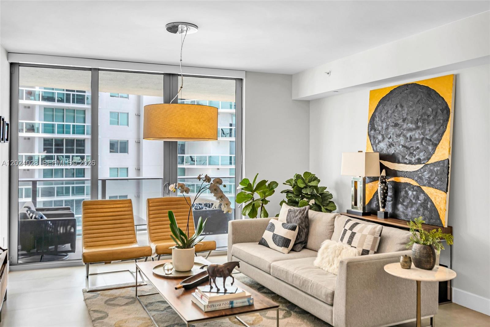 Waterfront Corner Luxury | Aria on the Bay #2011 | 2 BD + Den / 3 BA
Fully turnkey and beautifully furnished, this pristine corner residence at Aria on the Bay offers stunning views of Biscayne Bay, an abundance of natural light, and immediate investment or residential value. The spacious layout features 1,161 SQFT of living space with 2 bedrooms, a fully enclosed den, and 3 full bathrooms. Beautifully outfitted in premium Crate & Barrel contemporary furniture, the home boasts a bright open floor plan, sleek porcelain tile flooring throughout, floor-to-ceiling impact glass, Italian cabinetry by Italkraft, premium stainless steel appliances, and a secure private elevator entry foyer. Enjoy an expansive wraparound balcony offering excellent privacy, comfort, and fresh bay breezes. Aria on the Bay is a full-service luxury building with three levels of world-class amenities, including sunrise and sunset pools, a state-of-the-art fitness center, a yoga studio, a spa, and a movie theater. Located right across from Margaret Pace Park, residents enjoy an incredible waterfront lifestyle with tennis courts, beach volleyball, dog parks, and a local weekend farmers market. For an effortless weekday commute, the free water taxi picks up blocks away at the marina, dropping you directly in Sunset Harbour for dinner at Pura Vida while completely skipping causeway traffic. Centrally located in Edgewater with seamless access to Miami Beach, the Design District, Wynwood, and Downtown.