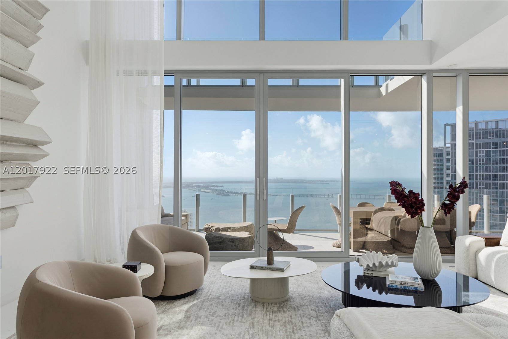 Aston Martin Residences, 5002. Enter through the East Tower into your private foyer on the 50th floor, where sweeping Biscayne Bay and Brickell skyline views unfold. One of only three duplex residences in the entire building. This expansive home features 5 bedrooms + den, 5.5 bathrooms, and dramatic double-height ceilings. The oversized primary suite is located on the second level and features a private terrace. The residence also includes a separate suite, ideal for staff quarters. Aston Martin Residences offers over 42,000 SF of world-class amenities across four levels, including a sky deck with pools, state-of-the-art fitness center, full-service spa and wellness center, two private theaters, golf simulator, business center, and concierge services offering private chauffeur transportation, beach access, and curated resident programming. Its sleek modern design and prime waterfront location make it one of Miami’s most prestigious addresses.