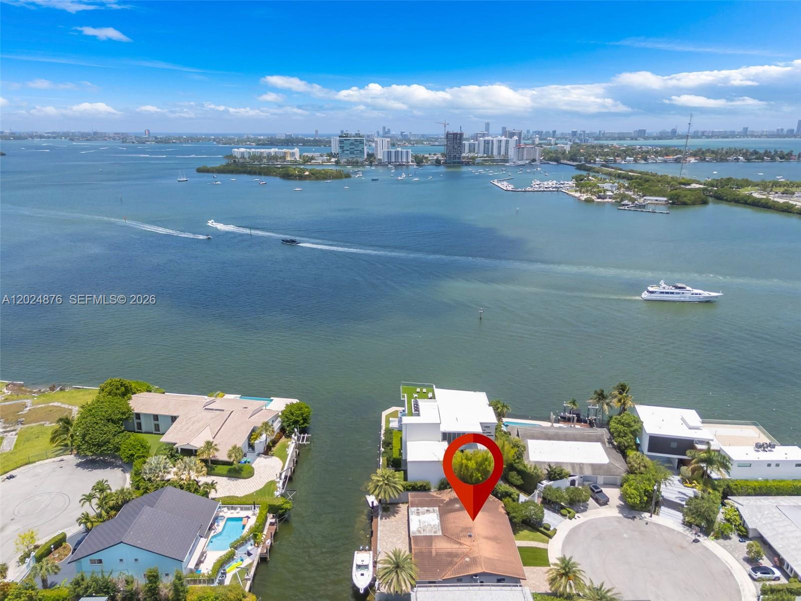 This is a boater's dream home! Due to being the "second" house from the bay it's quick and easy to access the bay from the residence's Boat or Jet-Ski lift. Boat lift holding up to 24,000 pound boat. Close boat ride to haulover sand bar or towards Miami Beach area. Backyard has exceptional room for the ultimate South Florida lifestyle, with extra room for a new pool. Grilling can be done at ease with extra countertop space outdoors. This house has enough paved space for multiple cars on the property. With a large family/florida room perfect for the best family game nights. Make this your full time residence or the perfect vacation home in Miami!