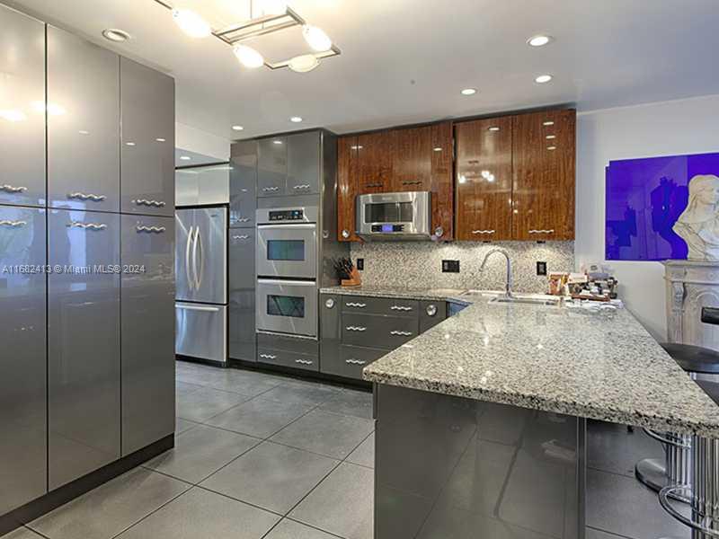 Garden Courtyard Entry! This 3750+ SF 3bed/4.5 bath tri-level townhome is nestled in between colorful bougainvillea flowers and beautiful fountain. Features volume ceilings, open marble stairway, interior elevator and renovated contemporary kitchen. Two huge beds/baths on second level and spacious Master/sitting room on entire third level. Enjoy views of the waterway/pool from your living/dining/master bed. Lots of storage/walk in closets throughout. Resort style amenities include brand new state of the art gym/spa, tennis/pickle ball and on site waterfront restaurant & marina.