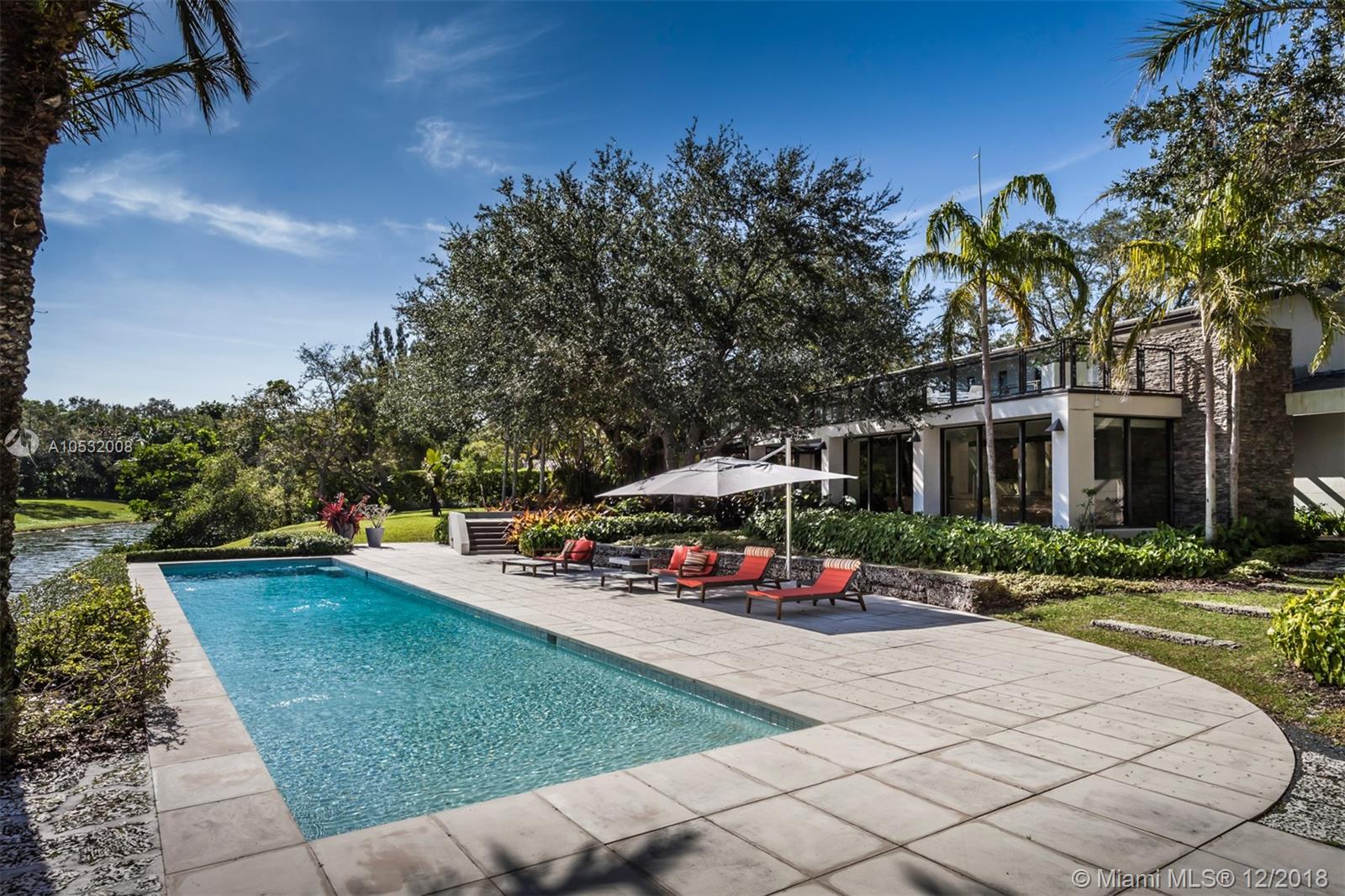 Masterful design and luxury are showcased in this immaculate lakefront home located in the exclusive guard gated Snapper Creek community. Impeccable landscaping surrounding the waterfront residence provides optimal privacy and a tranquil, serene outdoor setting. An open floor plan outlined with grand vertical windows and a stunning skylight overhead highlights sprawling entertainment areas flowing into private outdoor spaces.  The elegant home features a chef’s kitchen with Sub-Zero and Thermador appliances, a separate bar area and an oversized walk-in kitchen pantry. Every detail of this home including a sauna, fire pit and whole house generator was carefully selected. Amenities include access to a private marina with a full-time dockmaster with a boat slip or dry dockage option.