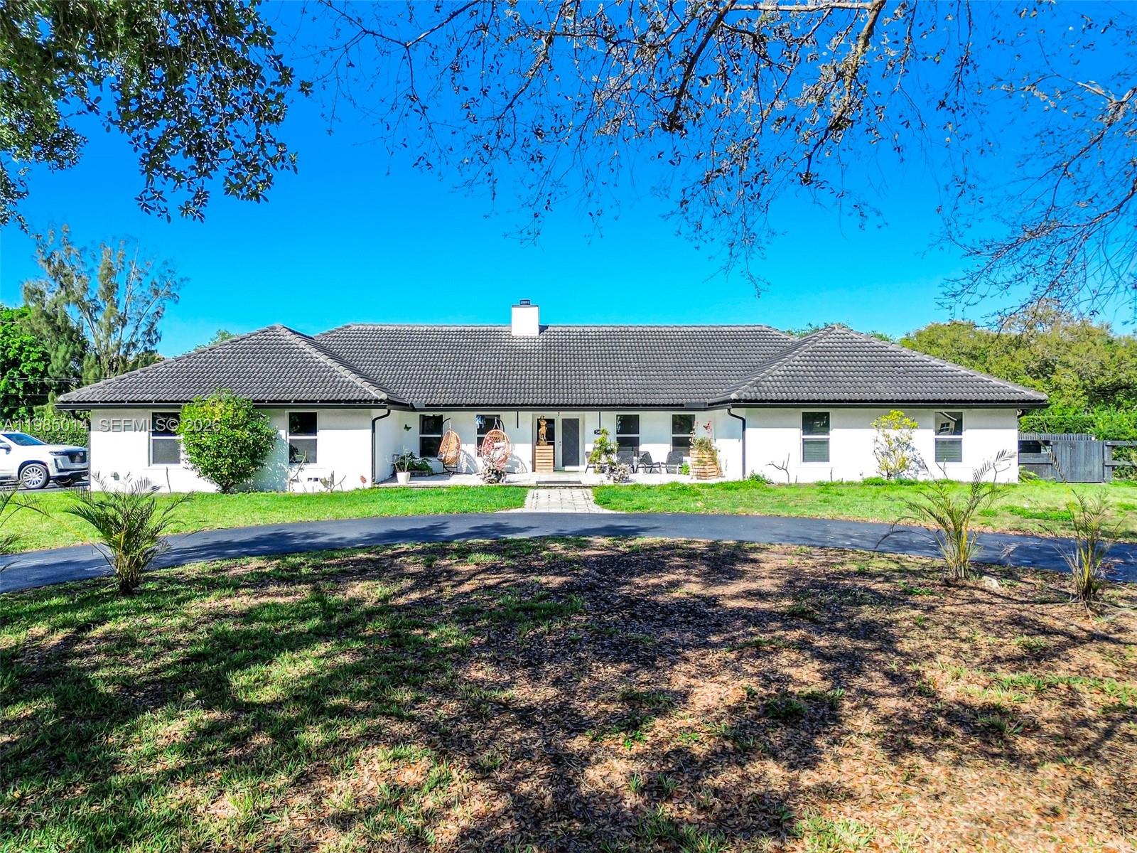 Welcome to a rare opportunity in the heart of Davie! Situated on a prime corner lot over an acre, this beautifully maintained property offers the perfect blend of space, functionality, and lifestyle. The main home features a thoughtfully designed layout with a private office, gym, and game room ideal for both everyday living and entertaining. Along with 5 bedrooms! 

The recently remodeled kitchen showcases modern finishes and flows seamlessly into the living areas, while impact windows and doors provide peace of mind throughout. A 5-year-old roof adds to the home's overall value and condition.

Step outside to your private backyard oasis, complete with lush landscaping, a screened-in pool, covered patio, and a fully equipped outdoor kitchen perfect for entertaining. The expansive lot also features a large detached shop, ideal for car enthusiasts, business use, storage, or even accommodating animals.

Additional highlights include a circular driveway, dedicated slabs for RV and boat parking, and a 200’ well water system.