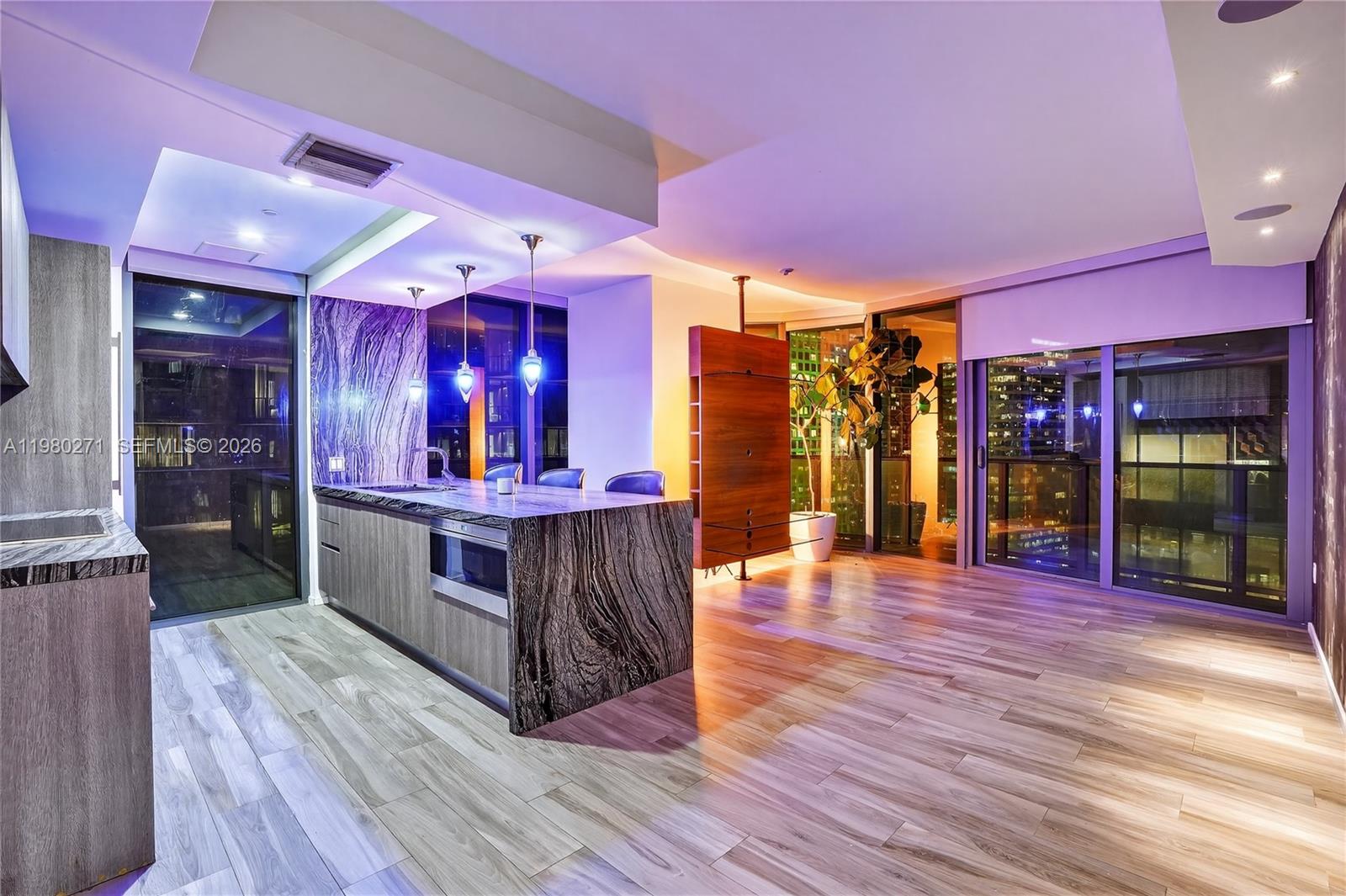 Stunning 28th-floor corner residence at SLS Brickell featuring private elevator access directly into the unit. This highly desirable layout offers expansive floor-to-ceiling glass, abundant natural light, and sweeping Brickell skyline views from a spacious wraparound balcony. Modern open kitchen with large stone island, custom cabinetry, and premium appliances flows seamlessly into the living and dining areas—perfect for entertaining. Spacious split floor plan with generous bedrooms and contemporary finishes throughout. Luxury building amenities include rooftop pool, full-service spa, fitness center, concierge, and on-site dining. Prime Brickell location just steps from Brickell City Centre, Mary Brickell Village, and top restaurants.