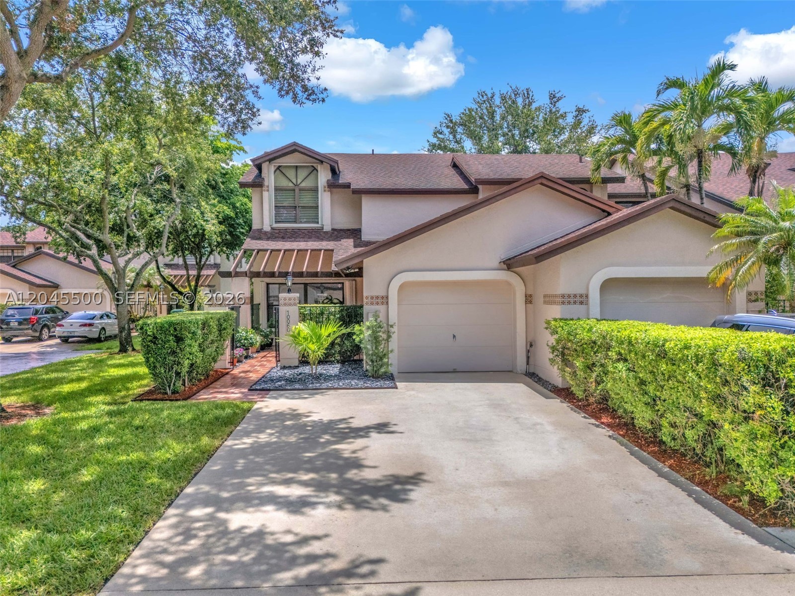 Rarely available, the largest model in the gated Valencia community! This beautifully remodeled 3BR/2.5BA corner-unit townhouse offers over 1,800 sq ft of pristine living space and a 1-car garage, with no attached neighbor on one side for maximum privacy. The bright, open layout features a kitchen equipped with a premium Bosch dishwasher (2022) and newer stainless-steel appliances (2021) that beautifully overlooks the backyard. The spacious primary suite boasts dramatic vaulted ceilings and an excellent walk-in closet. Just down the hall, you will find two bright guest bedrooms, with one room featuring high-end custom built-in shelving from The Container Store. Step outside to a fully tiled backyard with a stunning custom wood-beamed covered patio, meticulously designed as a tranquil bird and butterfly sanctuary. Best of all, the backyard does not face any neighbors, offering complete and serene privacy. Enjoy total peace of mind with a brand-new A/C (June 2026), accordion shutters throughout, and secure gated living. The low $180/mo HOA fee includes pool access, security, lawn care, common area maintenance, and exterior painting. All offers must include a D/U & pre-approval letter, or proof of funds if cash. Seller's disclosure attached.