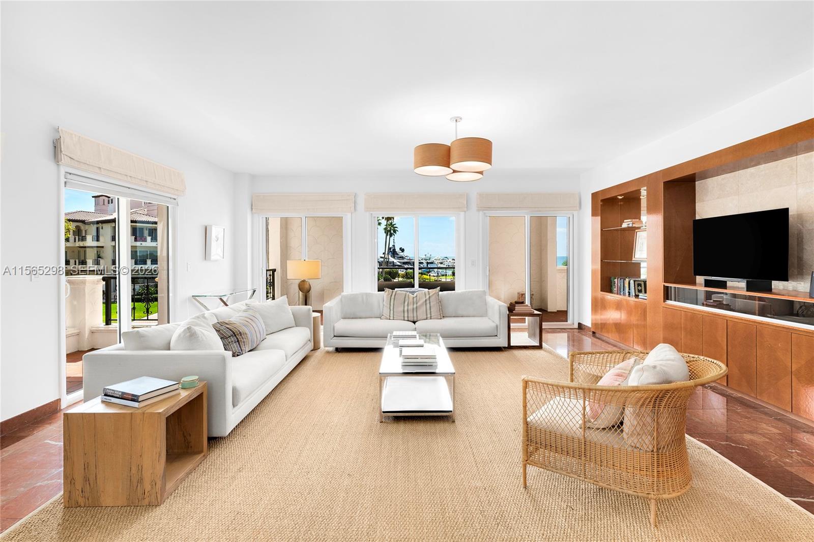 This corner unit at Bayside Village offers breathtaking views of Biscayne Bay, Fisher Island Marina, & the Atlantic Ocean. The unit features 3BR/3+1BA & 2,744 square feet of living space with 5 separate terraces. Spacious open dining & living room layout w/large windows streaming natural lighting w/access to 2 side terraces & a large bayside terrace w/direct Bay views. Kitchen sports granite counter tops & backsplash, cabinetry with built-ins, recessed lighting & a separate breakfast area. A spacious principal suite has a large walk-in closet, and direct access to the large terrace overlooking the pool, marina & bay. Principal bath boasts a walk-in glass shower, sunken spa tub & private water closet. Two other bedrooms with en-suite baths. Great location, near all Fisher’s best amenities.