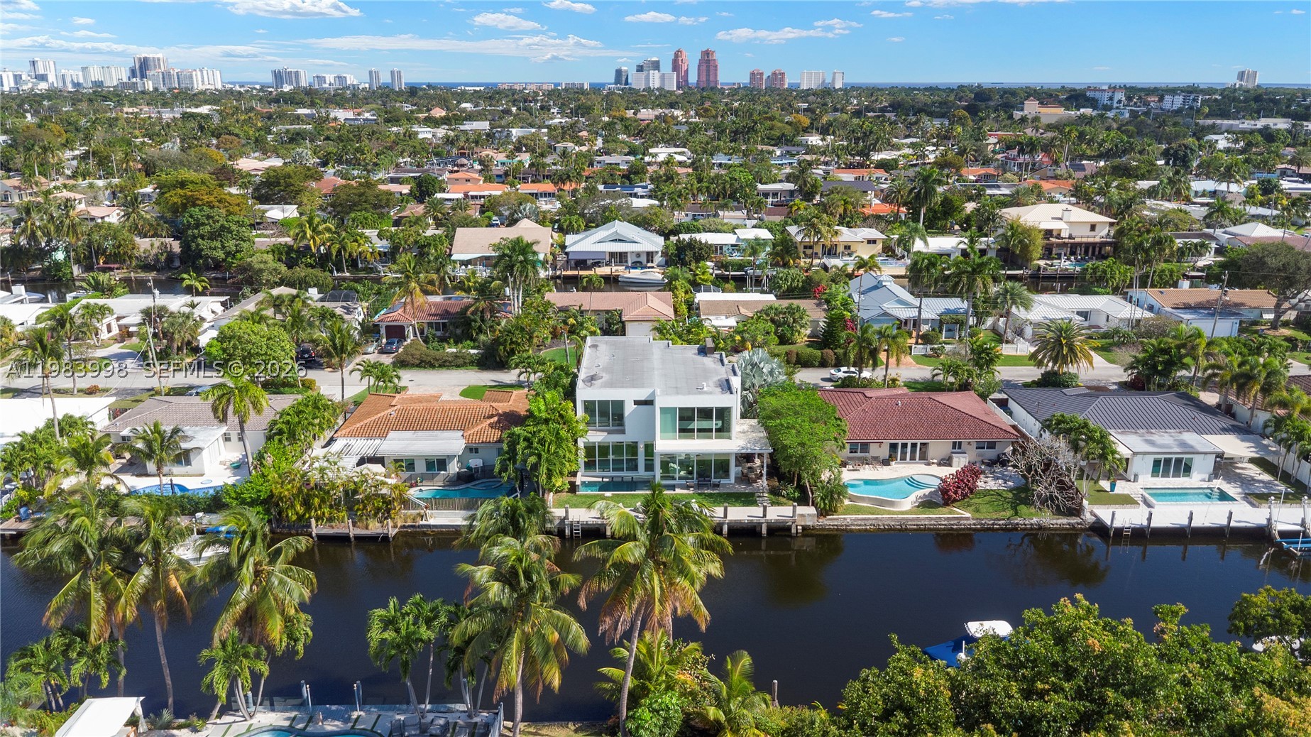 MOTIVATED SELLER - PRICED TO SELL! The BEST Deal For A Waterfront Home! Presenting A Luxurious Contemporary Home Built In 2018. Tastefully Decorated By Interior Designer. 4 Smart TVs. This Custom House Has High-Quality Finishes, 25 Ft. Ceilings, Featuring An Abundance Of Windows & Doors That Bring The Outdoors In, 2-Story Modern Home With Natural Light & Showcasing The Tropical Setting. Kitchen Has Top-Of-The-Line Appliances, Lots Of Storage, Making It A Chef's Dream. An Outdoor Patio & Summer Kitchen. Anti-Mosquito System, Custom LED Lights. The Primary Bedroom On The First Floor Has Gorgeous Views Of The Pool & Water. 70 Feet Of Water Frontage & Access To The Ocean. This House Is Located On A Quiet Street, Offering Privacy and Tranquility. Just Minutes Away From Trader Joe's, Whole Foods & Newly Opened Pura Vida!