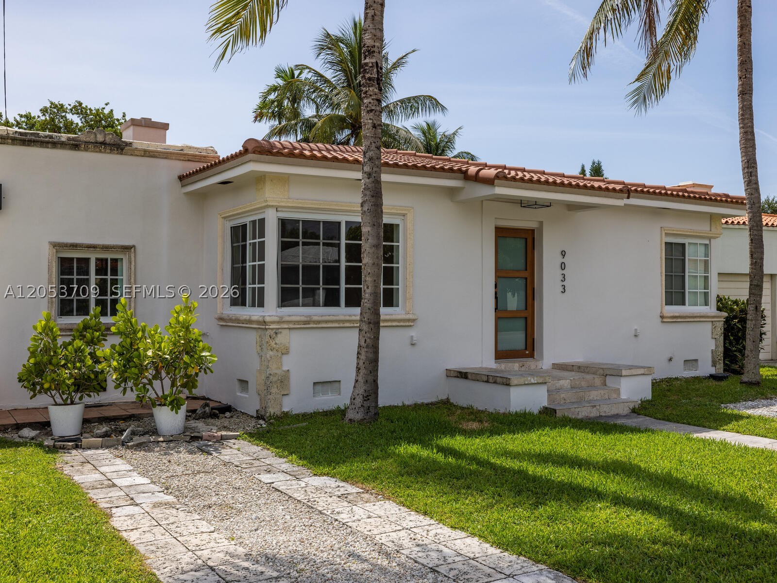 Welcome to Casa Coral! In the heart of Surfside and just 4 blocks from the ocean, this spacious, bright and updated 3bed/3bath home has been lovingly maintained and offers a great blend of original details and modern finishes. Enter into the extra-large sun-drenched living room with refinished wood floors and charming fireplace. Updated kitchen with new refrigerator and breakfast bar is open to the large dining area. Adjacent quarry-tiled sunroom features doors to the back pergola-covered deck and fenced-in gardens with room for a pool. Two of the three spacious bedrooms feature en-suite baths, including the bright main suite retreat with ample closet space. All hurricane windows-doors, newer A/C, plus a perfectly appointed laundry room with newer washer & dryer and tons of storage!