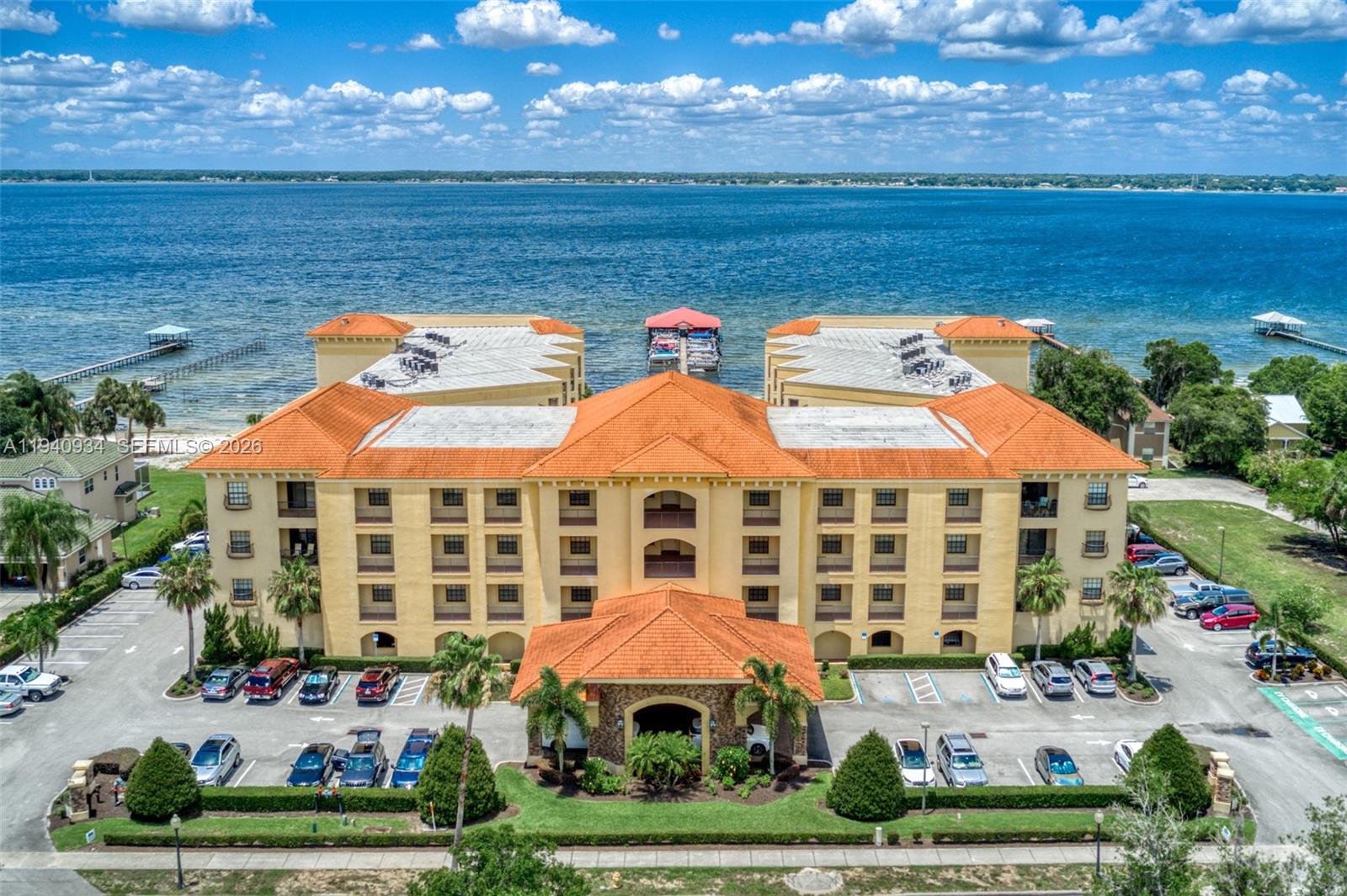 Discover luxury living at its finest in this resort-style condo, offering an elegant blend of international charm and modern comfort. Nestled in an exclusive waterfront community along the shores of Lake Jackson, this residence provides a rare opportunity to enjoy Mediterranean-inspired architecture and a host of first-class amenities. Residents are welcomed by an impressive lobby and reception area and have access to a state-of-the-art fitness center, a striking waterfall that flows into a negative-edge pool, a 36-slip marina, and 300 feet of private sandy beach.

Inside, you’ll find a thoughtfully designed split floor plan with open living spaces and a private balcony overlooking the sparkling pool and serene lake.

The spacious primary suite is a true retreat, featuring dual walk-in closets, dual vanities, an oversized Jacuzzi tub, and a separate walk-in shower. With every detail designed for comfort and sophistication, this condo offers a lifestyle of ease and refinement. Ideally located near historic downtown Sebring, it’s the perfect place to enjoy fine dining, boutique shopping, and the natural beauty of central Florida.

A must-see for those seeking luxury, elegance, and an unparalleled lakeside setting.