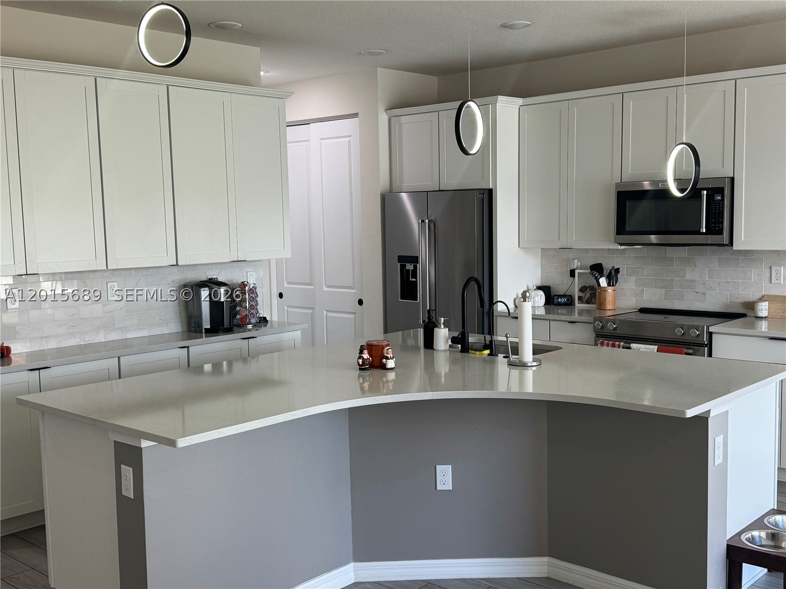 INVESTOR GOLDMINE OR FUTURE LUXURY HOME! Immediate, turnkey income-producing asset generating $3,990/month with an excellent tenant in place until Jan 2027 with the option of Flexible Timeline for Owner-Occupants, Experience luxury lakefront living in this stunning 2022-built residence located in the highly sought-after gated community of Oak Tree. This spacious 3-bedroom, 2.5-bath home offers breathtaking water views, hurricane-impact windows and doors, smart home technology, energy-efficient features, and premium upgrades throughout. The bright open-concept layout showcases high ceilings, abundant natural light, elegant finishes, and a chef-inspired kitchen with quartz countertops, stainless steel appliances, oversized island, and ample cabinetry. Upstairs, the spacious primary suite features serene lake views, walk-in closets, and a spa-style bathroom with dual vanities and glass-enclosed shower. Additional upgrades include Solar Power Energy Benefit, a whole-house water filtration system, EV charging connection, smart thermostat, and Ring security system. Enjoy resort-style amenities including clubhouse, fitness center, pickleball courts, pool with cabanas, BBQ area, dog park, and more. Conveniently located near major highways, shopping, dining, beaches, and Fort Lauderdale Airport.
