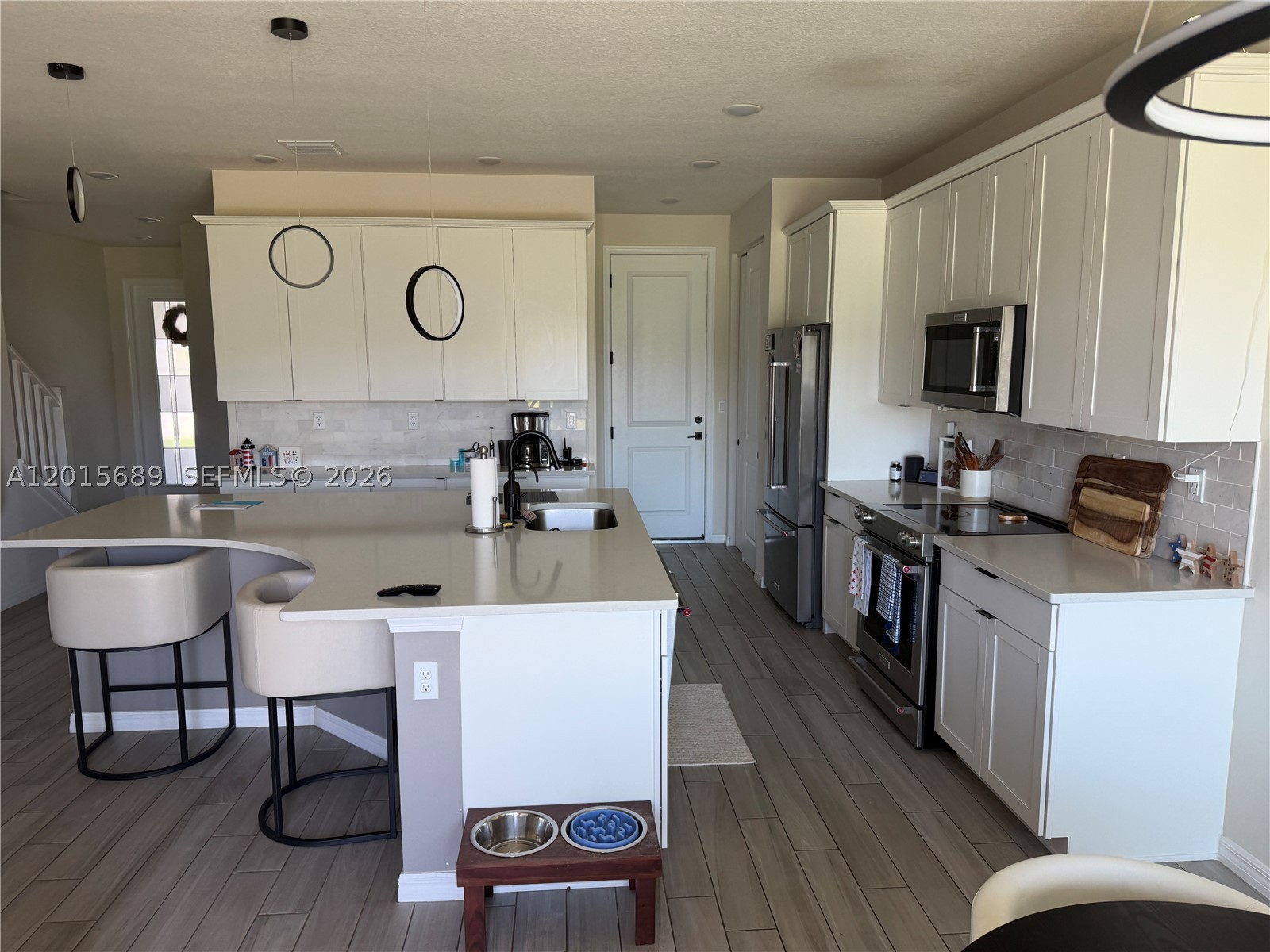 INVESTOR GOLDMINE OR FUTURE LUXURY HOME! Immediate, turnkey income-producing asset generating $3,990/month with an excellent tenant in place until Jan 2027 with the option of Flexible Timeline for Owner-Occupants, Experience luxury lakefront living in this stunning 2022-built residence located in the highly sought-after gated community of Oak Tree. This spacious 3-bedroom, 2.5-bath home offers breathtaking water views, hurricane-impact windows and doors, smart home technology, energy-efficient features, and premium upgrades throughout. The bright open-concept layout showcases high ceilings, abundant natural light, elegant finishes, and a chef-inspired kitchen with quartz countertops, stainless steel appliances, oversized island, and ample cabinetry. Upstairs, the spacious primary suite features serene lake views, walk-in closets, and a spa-style bathroom with dual vanities and glass-enclosed shower. Additional upgrades include Solar Power Energy Benefit, a whole-house water filtration system, EV charging connection, smart thermostat, and Ring security system. Enjoy resort-style amenities including clubhouse, fitness center, pickleball courts, pool with cabanas, BBQ area, dog park, and more. Conveniently located near major highways, shopping, dining, beaches, and Fort Lauderdale Airport.