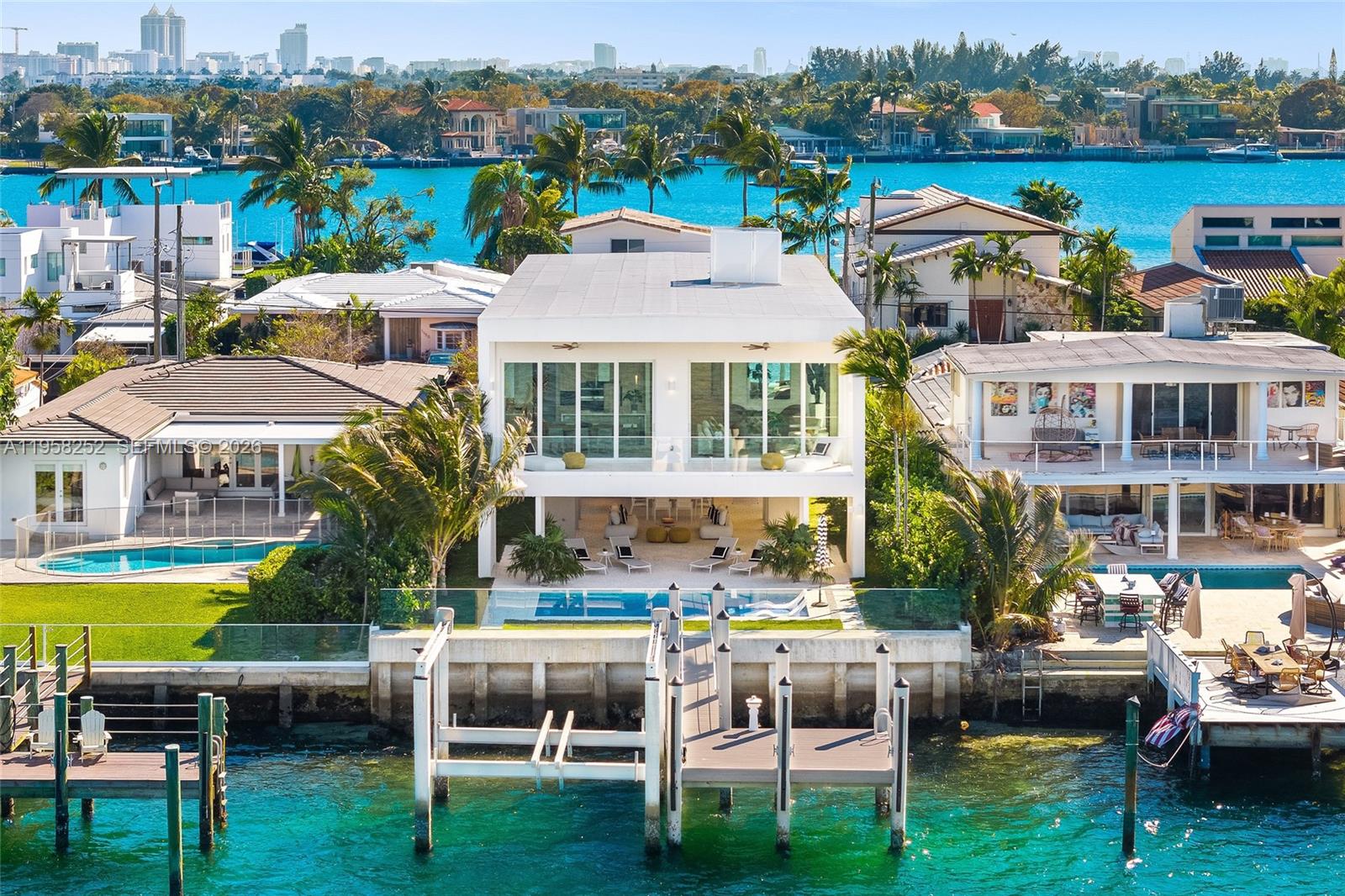 A striking expression of modern waterfront living, this newly constructed residence delivers scale, privacy, & direct access to Biscayne Bay within the gated enclave of Biscayne Point. Beautifully executed with flawless, high-end interiors, the home reflects the craftsmanship expected of true luxury new construction. Designed for entertaining & elevated coastal living, the residence offers 4 bedrooms & 3 bathrooms within 3,289 interior sqft. Spanning over 4,000 total sqft, the home sits over a two-car garage understory that enhances elevation, security, & functionality.

Set on a waterfront lot with 50ft of frontage, the property features a private dock & a new boat lift, offering effortless ocean access & no fixed bridges. Elevated on stilts, expansive covered ground-level spaces create an ideal environment for hosting & outdoor living, seamlessly connected to the water. Above, floor-to-ceiling glass frames open-concept living areas, filling the interiors with natural light & uninterrupted bay views.

Interior spaces are meticulously crafted, showcasing premium finishes, clean architectural lines, & exceptional attention to detail throughout. A generous balcony extends the primary living spaces outdoors, overlooking the water & pool in a resort-style setting. Ideally located moments from renowned beaches, dining, & luxury shopping, this home presents a rare opportunity to own new construction waterfront property in one of Miami Beach’s most desirable gated neighborhoods.