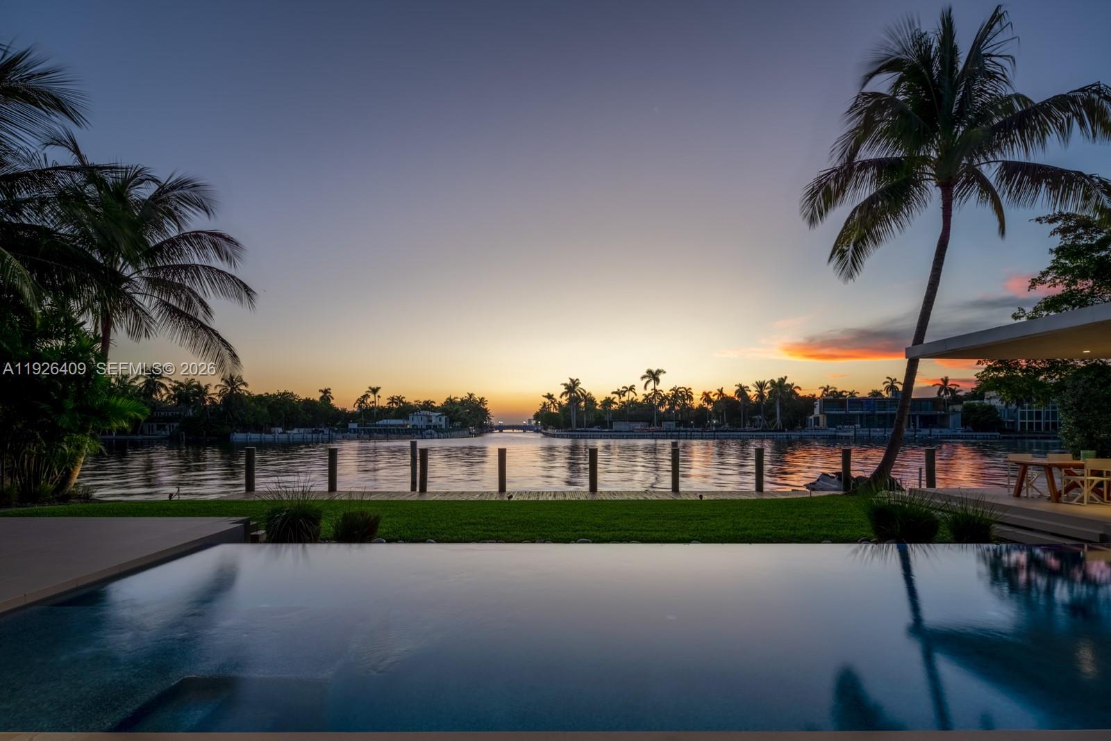 Tropical modern masterpiece on exclusive Allison Island, designed by acclaimed architecture & design firm Choeff Levy Fischman. The impressive residence spans 10,632 SF of interior space featuring 7 bedrooms, 9 full baths, and 2 half baths, a media room, wine cellar, and multiple living areas ideal for entertaining.

The expansive primary suite includes dual spa-inspired baths, walk-in closets, a sitting area, floor-to-ceiling windows, and a private terrace offering stunning sunset views. Additional features include dramatic 22-foot ceilings, two family rooms, and a junior suite with a private terrace.

The chef’s kitchen showcases custom Italian cabinetry with Sub-Zero and Wolf appliances, along with a separate staff/service kitchen and quarters. Situated on a 23,760 SF lot with 110 feet of water frontage, the home enjoys direct waterfront access and exceptional privacy.

Allison Island offers one of Miami Beach’s most exclusive guard-gated communities, providing 24-hour security within an intimate luxury enclave.