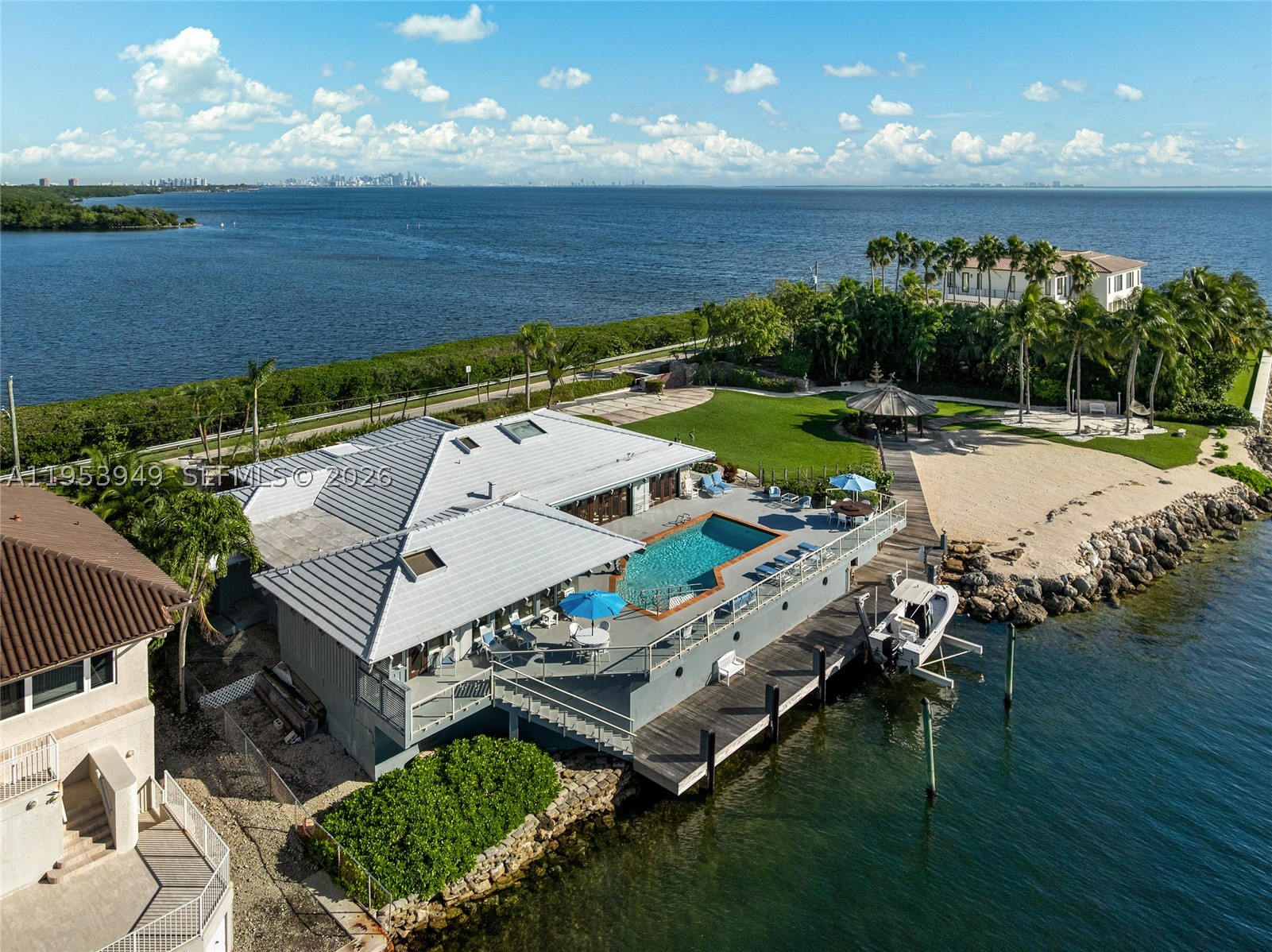 “My Paradise” earns its name! This 5BR/5BA estate sits on a 32,025 SF lot with 250’ of unobstructed pristine waterfront views on both sides, capturing mesmerizing sunrise-to-sunset across Biscayne Bay, Downtown, Miami Beach & Key Biscayne. Privately positioned at Lugo Avenue’s dead end, resort-style grounds feature lush landscaping, wooden & coral walkways, gazebo, sand beach, summer kitchen & serene fountains. Elevated pool deck w/glass railings frame sweeping bay & island vistas. Spacious open living room w/pitched wood-beam ceilings, skylights, formal dining, kitchen w/Bosch & Sub-Zero appliances. Principal suite offers amazing bayside views & spa bath. A yachtsman’s dream includes 66’ dock w/lift, boathouse & plans in progress to extend to 100’. Minutes to dining, shops, & top schools.