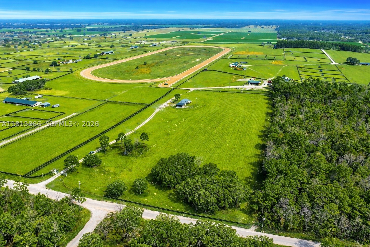Located within the prestigious Florida Mile Training Center, this exceptional 21+acre equestrian estate offers exclusive access to a meticulously maintained 1-mile training track. Designed for serious /novice equestrians, the track accommodates a variety of disciplines, including Thoroughbred and/or Quarter Horse racing, Standardbred and harness training & general horse fitness or rehabilitation. Featuring starting gate, watering system, and superior footing, this track provides optimal training conditions. With high and dry land ensuring year-round usability, it is the perfect setting for both professional and recreational equestrians. The estate also includes a small hay field, providing a sustainable feed source, reducing costs, and enhancing self-sufficiency for equestrian operations.