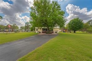 This well-maintained property sits on 2.5 mostly fenced acres, zoned for horses and livestock with plenty of room to ride. The home offers new flooring throughout, a brand-new kitchen (with newer appliances), updated bathrooms—including a handicap-accessible walk-in tub in the guest bath—a large screened front porch, a 2019 metal roof, and a whole-house generator with a 500-gallon propane tank (2025) it even has a wood burning fireplace in the living room. Additional features include an outbuilding, storage shed, and chicken coop. Not located in a flood zone (per FEMA flood map). Conveniently situated about an hour from Fort Myers and roughly an hour and a half from Miami or Fort Lauderdale.