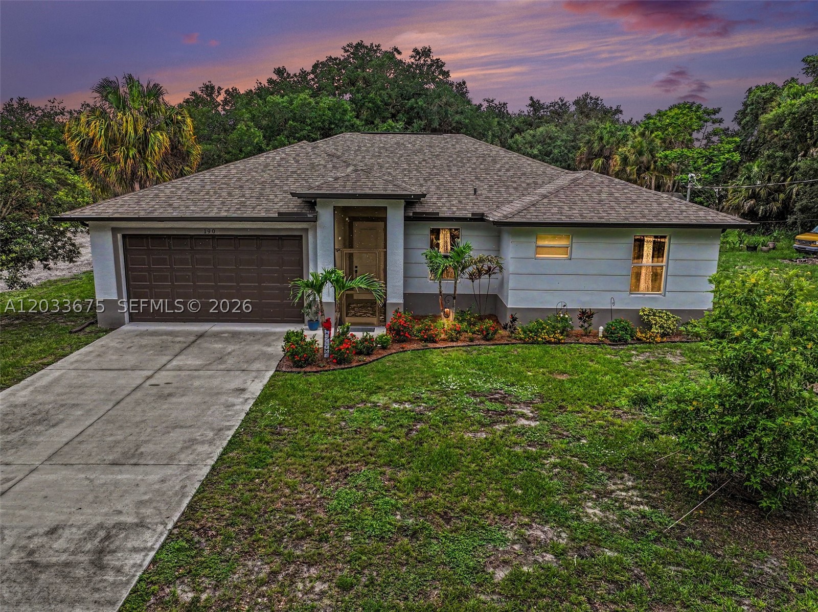 Pristine and showing like new, this 2023-built concrete block home offers hurricane-impact windows, exceptional energy efficiency, and modern finishes throughout. Located in a desirable downtown LaBelle neighborhood within easy walking distance of shopping, dining, schools, and other amenities, this property combines convenience with peaceful residential living. Situated on an oversized 0.344-acre homesite measuring approximately 100' x 150', the property features a wide double-car driveway, professionally designed landscaping, and a spacious privacy-fenced backyard. A large screened lanai spans the rear of the home, creating the perfect setting for outdoor entertaining and relaxation. The thoughtfully designed 3-bedroom, 2-bath split floor plan offers over 1 square feet under air and approximately 2,300 square feet total. The open-concept living area overlooks the scenic backyard and is enhanced by a decorative tray ceiling and ceiling fan. The beautifully appointed kitchen is sure to please the family chef, offering abundant cabinetry, workspace, and functionality. The oversized primary suite provides a private retreat with a large walk-in closet and an attractive ensuite bath featuring a luxurious walk-in shower. Additional features include a separate laundry room with access to the oversized garage, ample storage, and quality finishes throughout. Move-in ready and meticulously maintained, this attractive home offers the benefits of new construction without the wait.