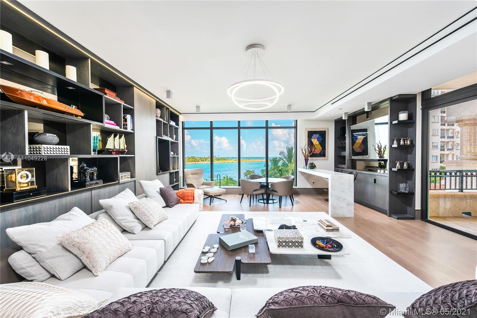 This one-of-a-kind 3 bedroom, 4.5 bath corner unit redefines luxury living in Fisher Island's newest building Palazzo del Sol. Professionally designed and decorated the unit is offered furnished. Interior finishes such as oak wood floors, custom built-ins, private elevator, 10' ft ceilings, Boffi kitchen with Gaggeneau & Subzero appliances, Boffi master bathroom with bookmatched marble, Lualdi doors, Apure lighting, wine cellar, bar, family room, den, etc. make this an exceptional unit. The expansive wraparound terraces are perfect for entertaining with views of gov't cut, ocean, Fisher Island, and the Miami skyline. Building amenities: butler-service aperitive bar, theatre, beauty salon, massage rooms, business center, concierge, valet, etc. Live the Fisher Island in this private oasis.