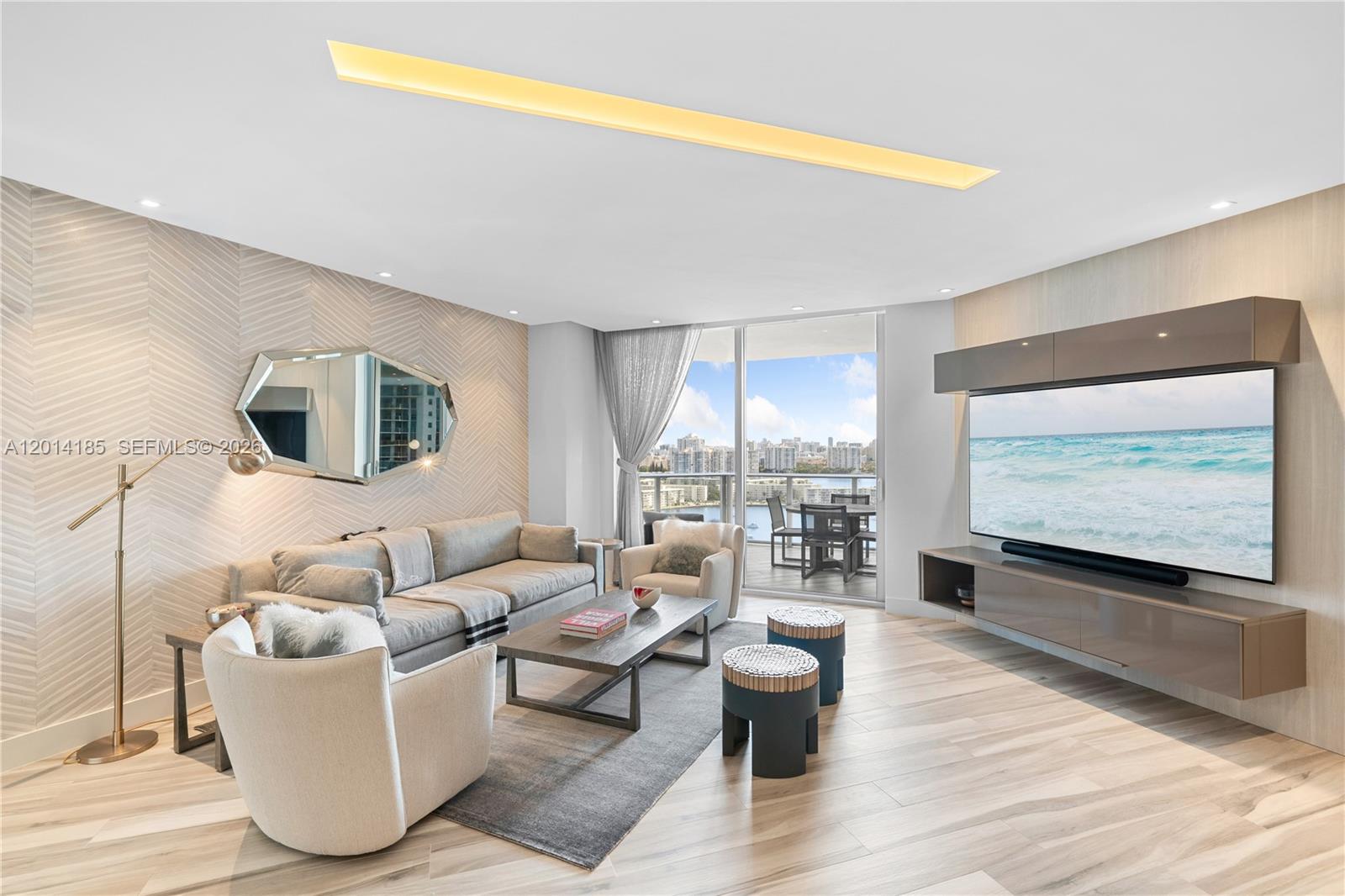 A refined residence at Marina Palms Reserve. Located on the 21st floor with sweeping unobstructed waterfront views. This 2-bedroom, 3-bathroom unit is designed around natural light, open spaces, and seamless indoor-outdoor living. The home has a massive floor plan, complimented by a large balcony positioned perfectly to overlook the bay and surrounding skyline. The kitchen is finished with Snaidero cabinetry and a full suite of Wolf and Sub-Zero appliances. A wet/wine bar creates a dedicated space for serving and entertaining friends and family. The primary suite is framed by floor to ceiling windows with a waterfront backdrop, and includes a sitting area with a custom built-in desk, ideal to work from home. The spa-inspired bathroom features a separate shower, floating tub, and an oversized dual vanity. While the primary closet is fully built out with custom Armadi cabinetry, offering exceptional storage and a polished, functional design. The final bedroom is en suite, and captures beautiful water views through the sliding glass doors that lead to the terrace. Marina Palms is a full-service marina community, with slips available for purchase or rent. This residence offers a polished lifestyle with direct access to the best of Miami's waterfront living.