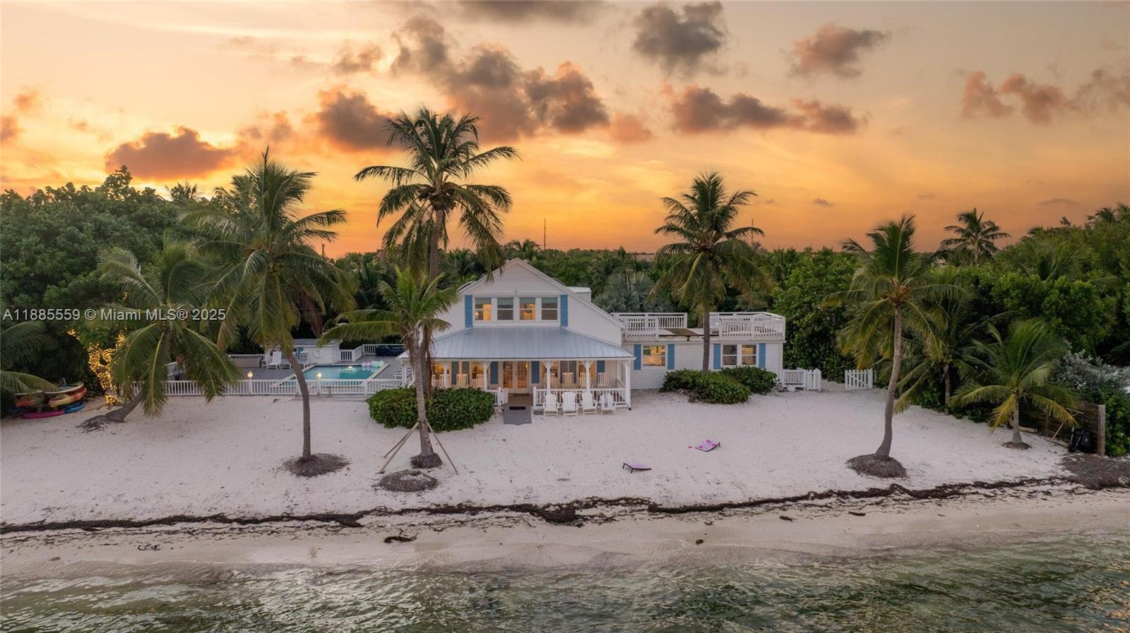 Iconic Islamorada Oceanfront Retreat. Welcome to The Last Resort, a one-of-a-kind oceanfront estate offering rare privacy and breathtaking natural beauty in the heart of Islamorada. Set on over an acre of lush tropical land, this coastal retreat boasts 165 feet of private sandy Atlantic beach, where you can launch a kayak or paddleboard right from your backyard and soak in endless turquoise views. Expansive covered verandahs, a 15' x 30' heated seaside pool, and beachside hammocks invite slow, sun-filled days and relaxed gatherings. Across the street, a separate canalfront parcel with a 37.5' concrete dock provides protected deep-water dockage and space for boats, trailers, and water toys — an extraordinary pairing of true beachfront living and convenient boating access.