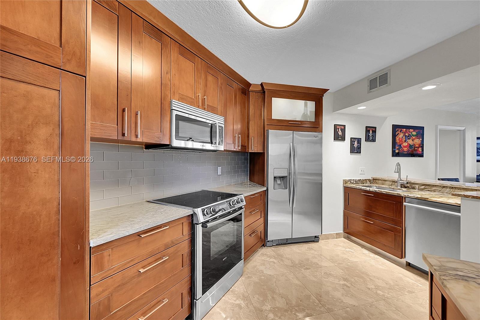 As a corner unit, you enjoy added privacy and a wrap-around balcony in one of Plantation’s most desirable areas! brand-new A/C system, elegant Italian porcelain flooring throughout. Wood custom cabinetry in the kitchen with built in LED's, high end faucets and all stainless-steel appliances, Bosch stove and convection oven, stainless fridge and microwave, walk in closet with built-in cabinets.