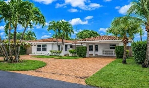 Welcome to your next home in the sought-after Coral Ridge Isles neighborhood of Fort Lauderdale. This charming three-bedroom, two-bathroom offers spacious living with tile floors throughout, creating a clean and modern aesthetic. Enjoy the convenience of new appliances. Step outside to find a delightful screened-in porch, perfect for relaxing, and a large fenced backyard offering plenty of outdoor space. Safety is a priority with impact windows and doors, and parking is a breeze with a carport and a paver circular driveway. Located just minutes from the beach, dining, shopping, and entertainment, this home combines comfort and convenience in a prime location. Don't miss this opportunity to call this your home.Only first month and security deposit to move in!