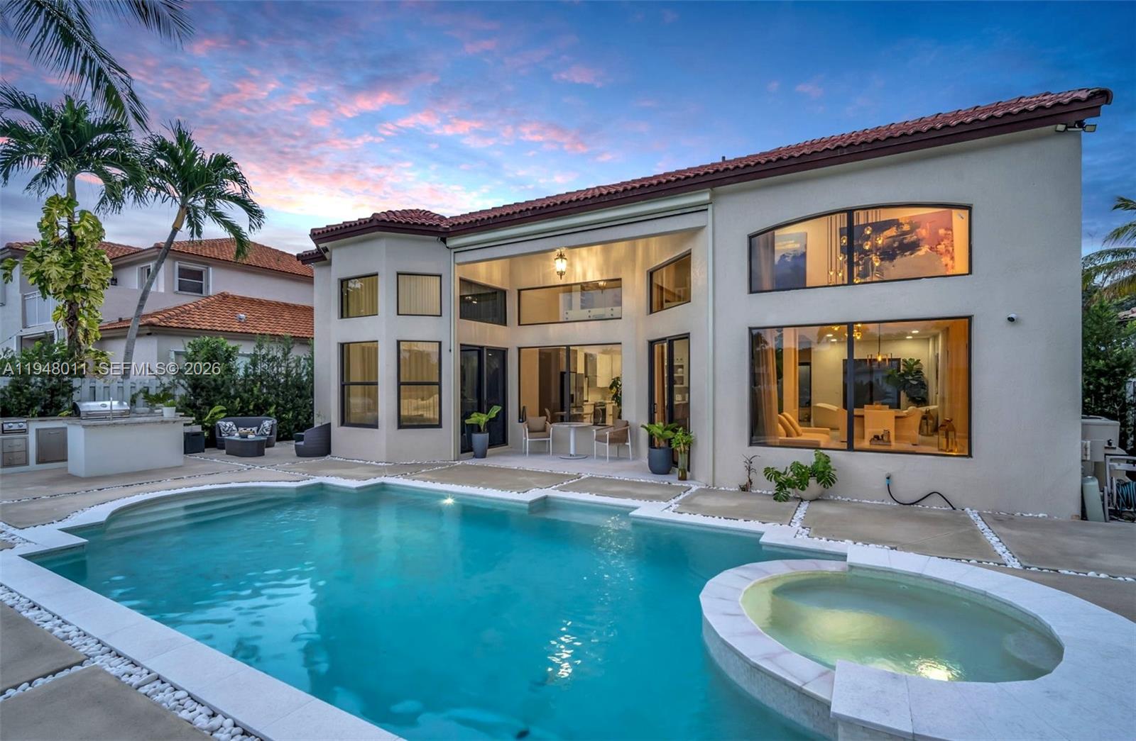*Luxurious Modern Waterfront Residence in Prestigious Gated Windsor Palms*
Experience elevated South Florida living in this fully renovated 5BR/4BA modern masterpiece. Offering 3,285 sq ft of refined living space on a 7,812 sq ft lot, this residence showcases high-end upgrades throughout and is located in one of Miramar’s most exclusive gated communities. Move-in ready. The home features soaring ceilings, abundant natural light, impact-resistant windows, and elegant marble flooring. The open-concept layout is perfect for entertaining, highlighted by a striking glass staircase, Italian marble fireplace, and custom luxury TV wall units. The gourmet chef’s kitchen boasts premium finishes, high-end appliances, and exceptional craftsmanship. The main-level en-suite master bedroom serves as a private retreat with a wood-slat feature wall, floor-to-ceiling remote controled curtains, and a breathtaking spa-inspired bath.
Step outside to a stunning backyard oasis featuring a 12x20 resort-style pool, spa, glass fence for unobstructed lake views, a serene sand-beach-style yard, a sunset sitting area, and a High-end outdoor grilling/bar lounge designed for unforgettable gatherings. This exceptional home delivers unmatched luxury, comfort, and style—offering a true everyday getaway within the security of a gated community. 

A must-see for buyers seeking a truly extraordinary property!